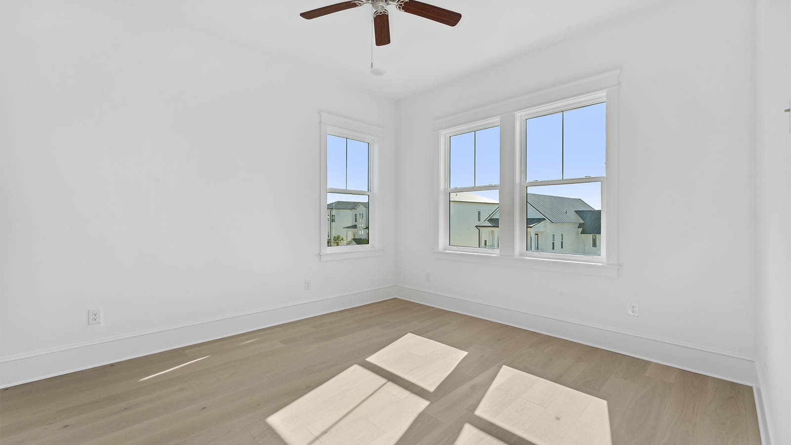 The guest bedrooms are located opposite the primary bedroom and are at the front of the home