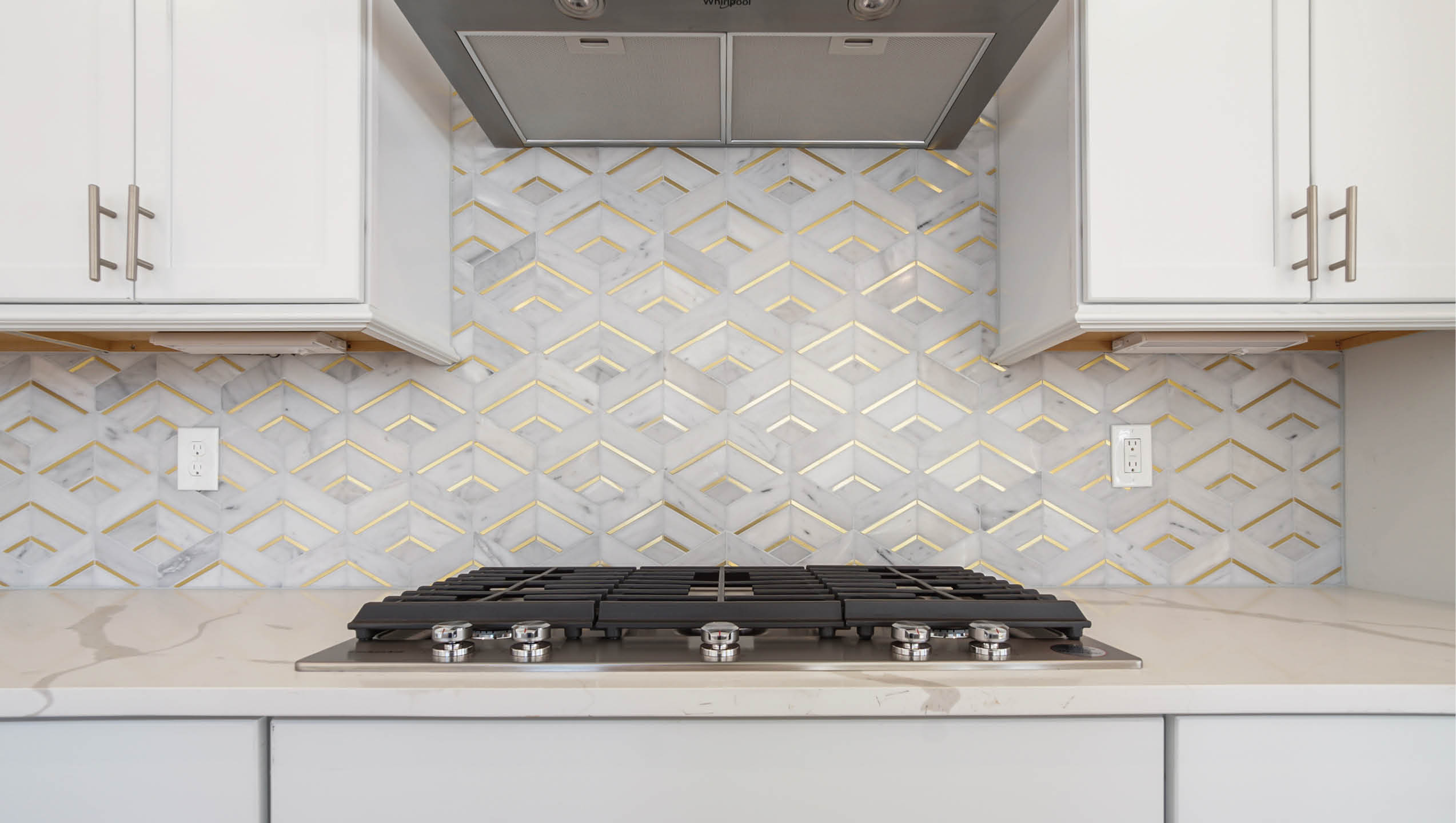 Gas Cooktop stove in kitchen with hood vent