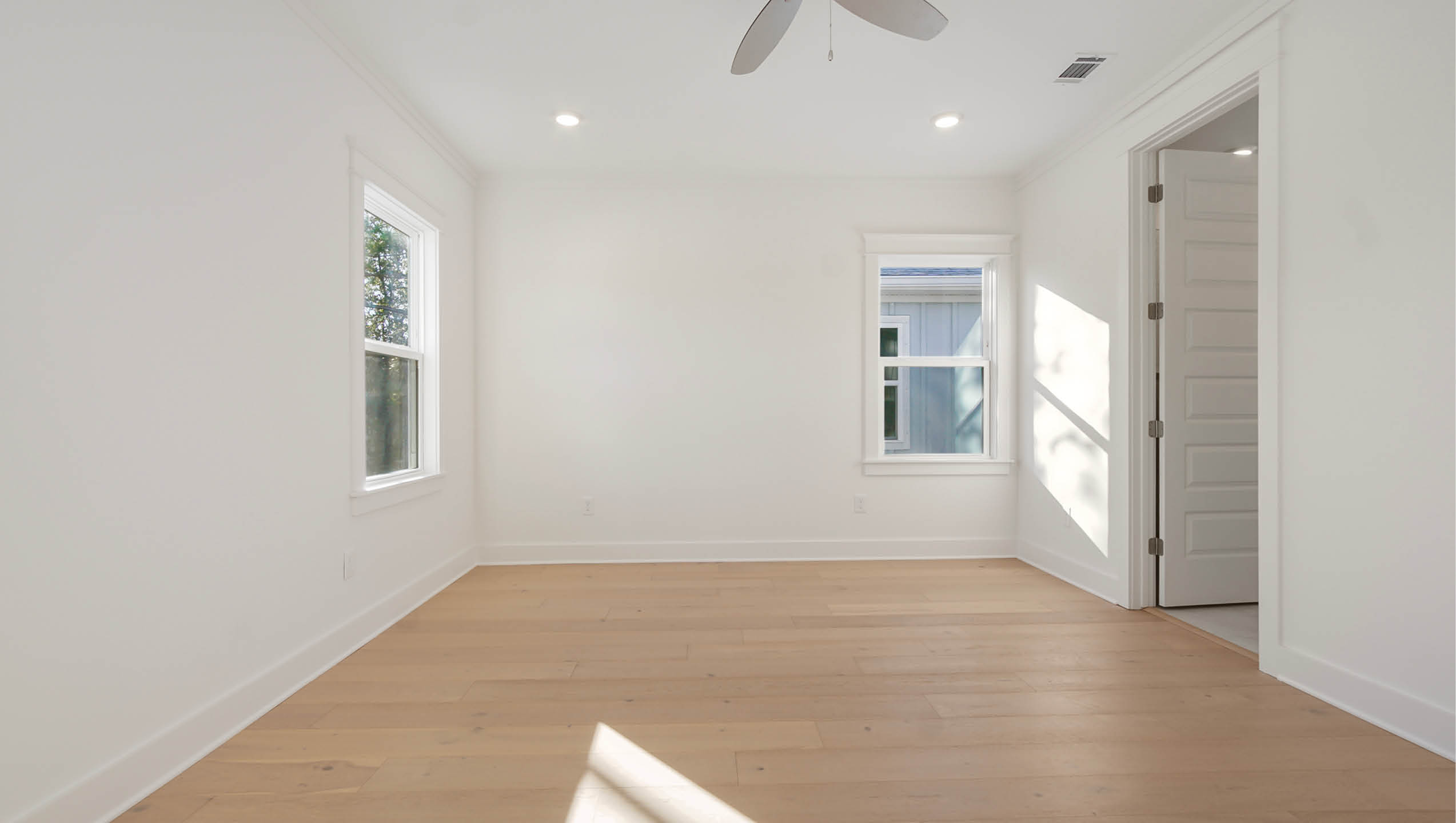 Primary bedroom with windows for natural light
