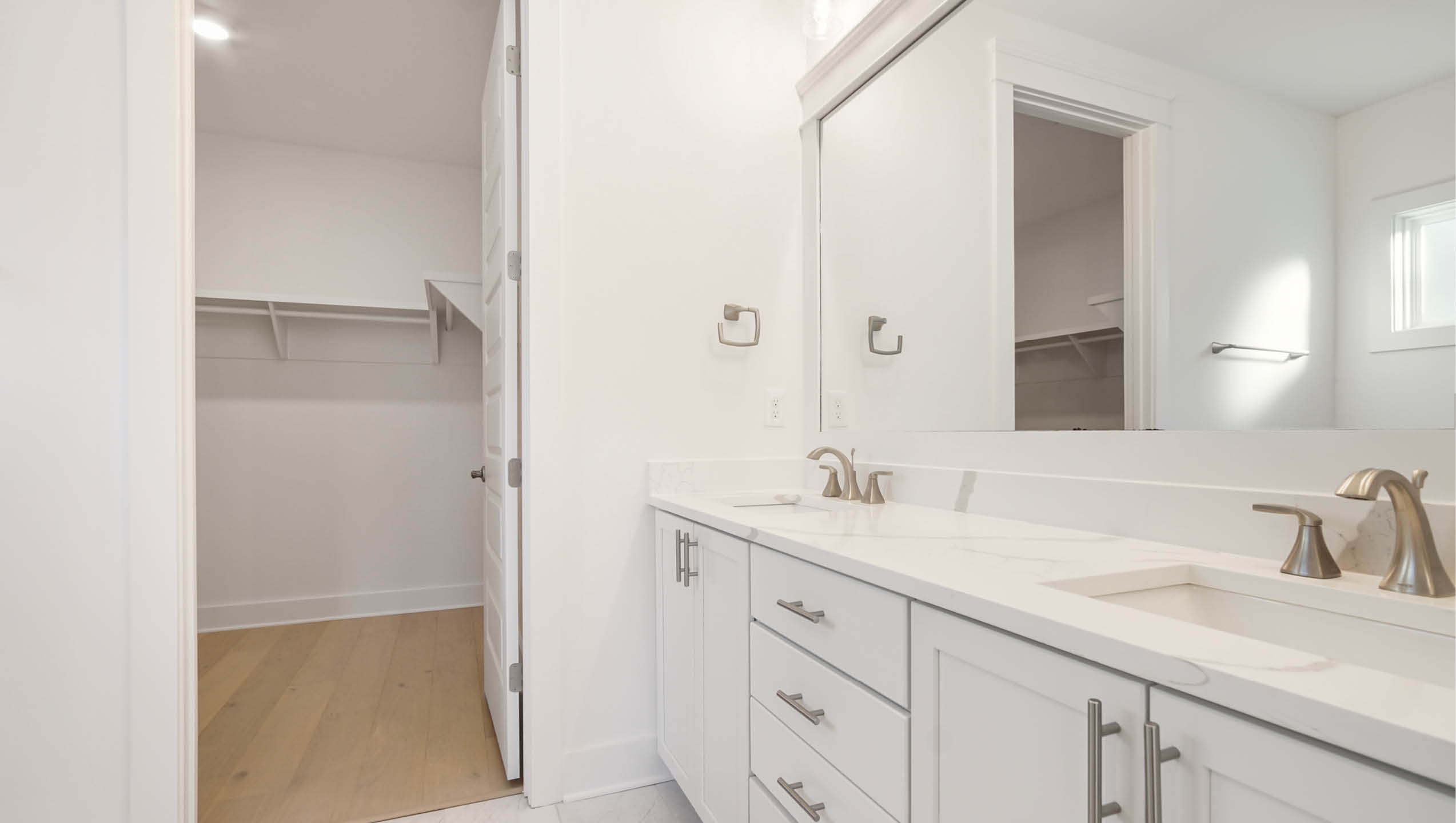 Primary bathroom with quartz countertop and large closet