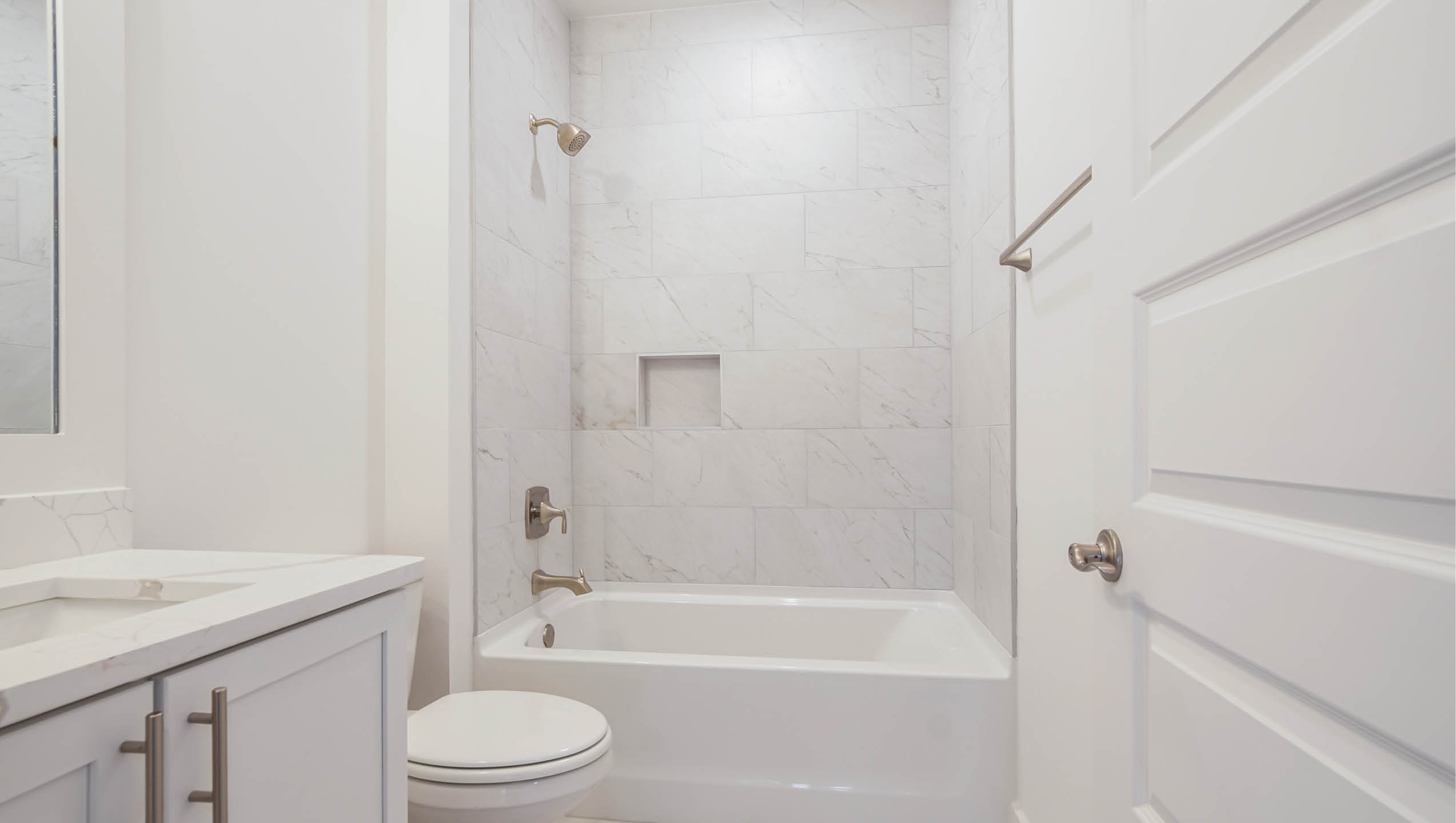 Private bath in bedroom five with shower tub combination