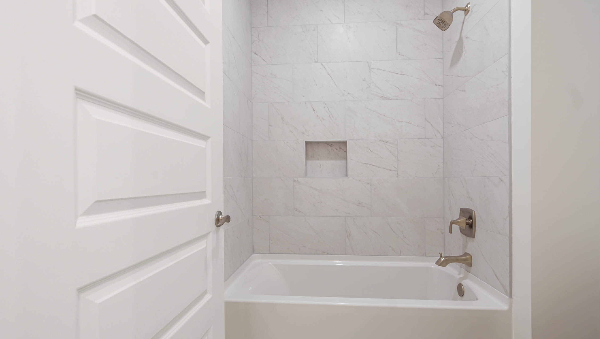 Shared bathroom has separate water closet and shower tub combinations