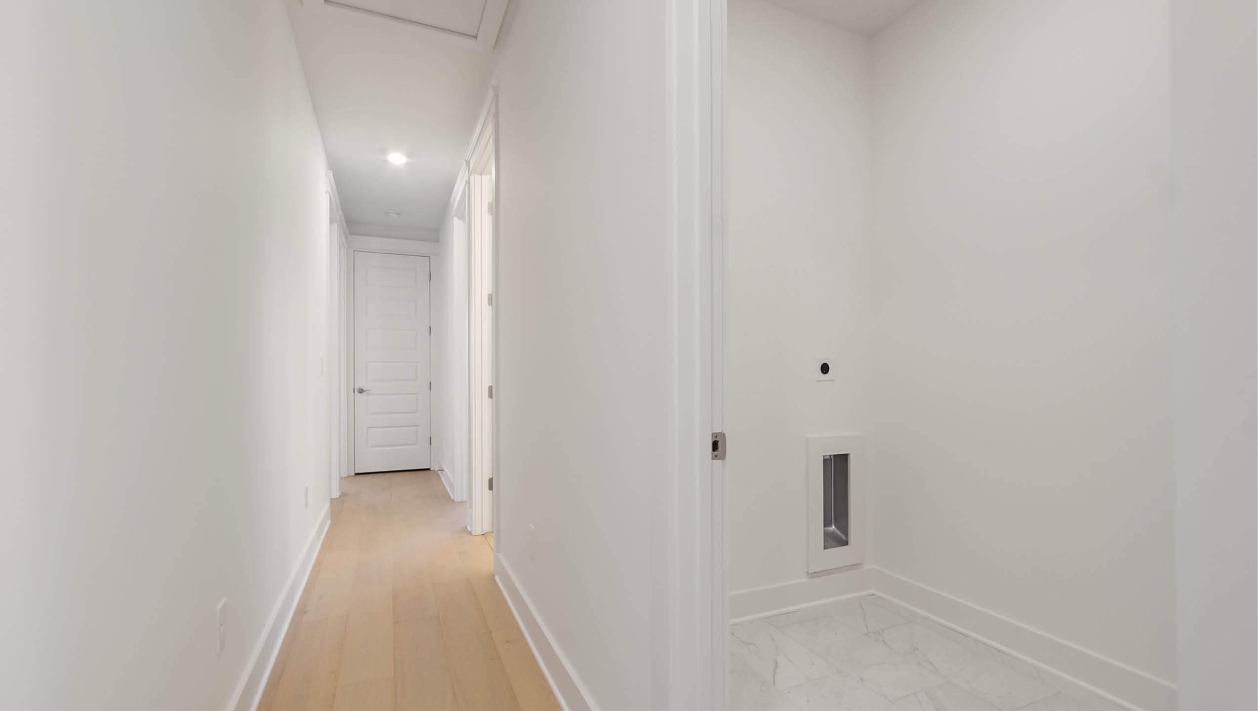 Hallway with laundry room leading to bedrooms three four and five