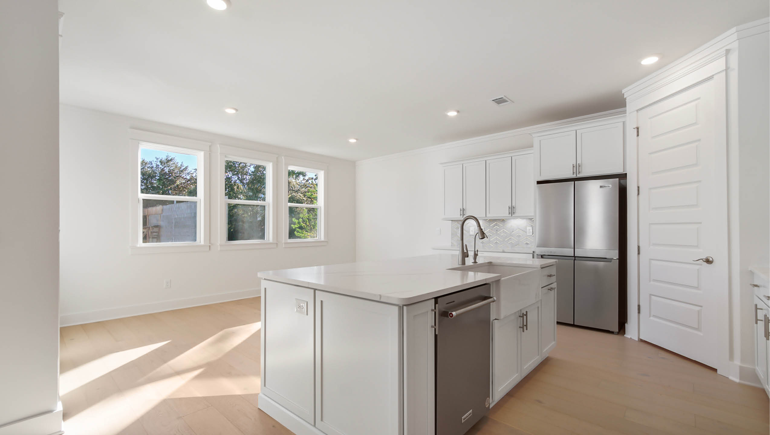 Spacious center island with quartz countertop and dishwasher and sink for easy meal prep and cleanup