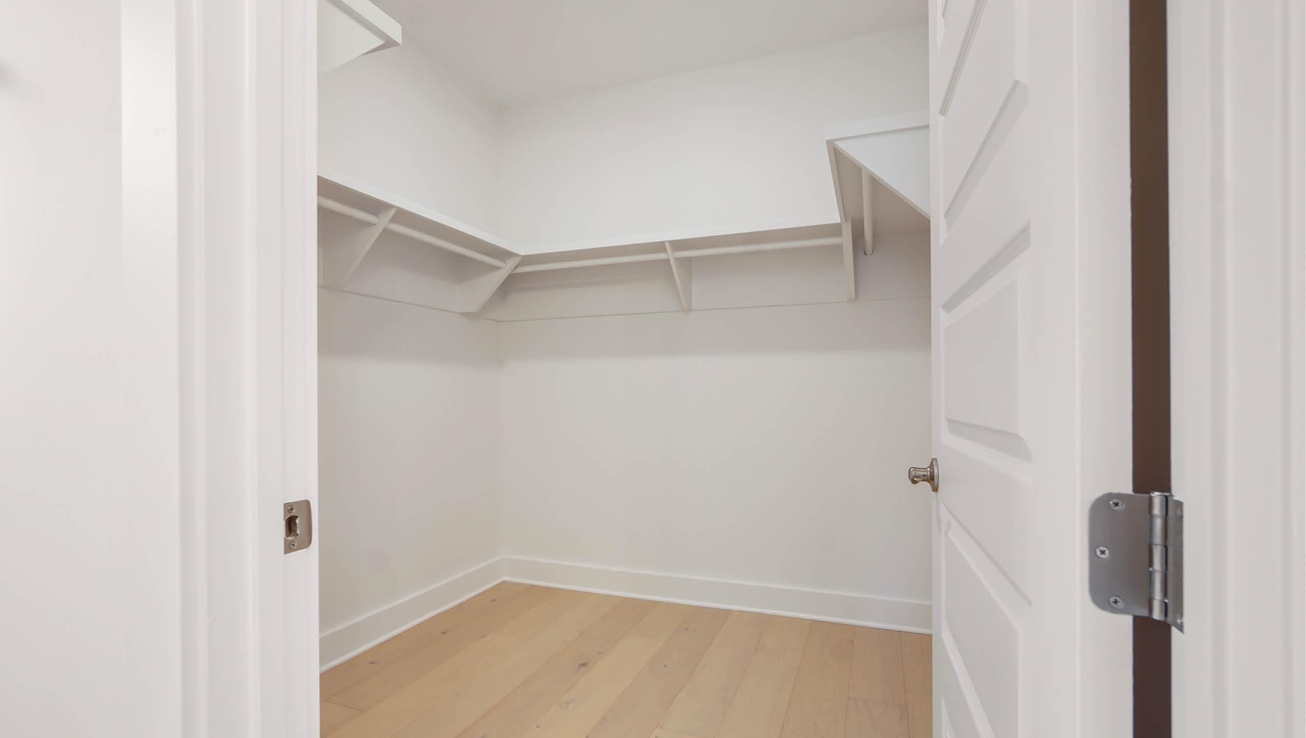 Large closet with shelving in primary bathroom