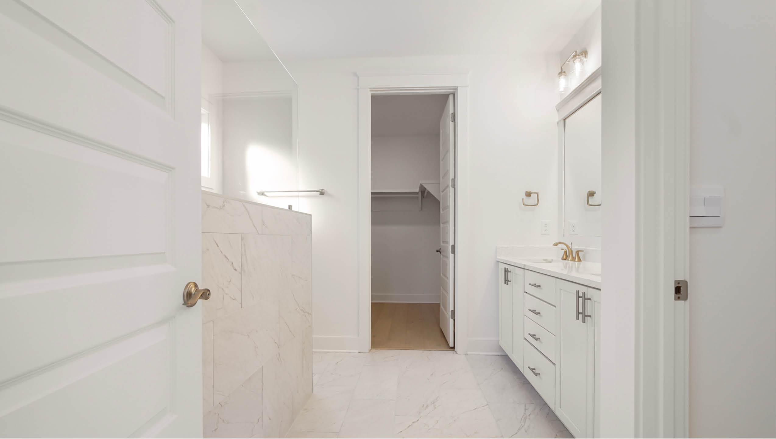 Primary bathroom with dual sink vanity and beautiful cabinetry for storage