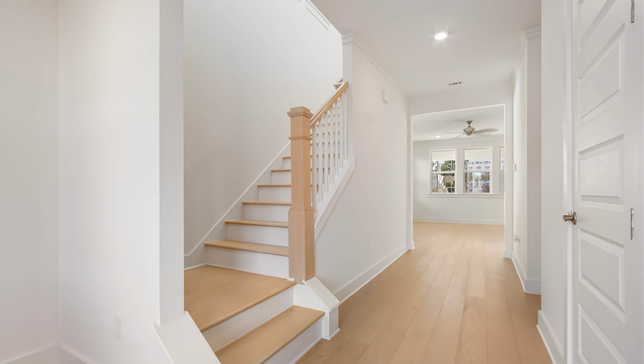 Bright entry hall leading to the main living area and upstairs bedrooms