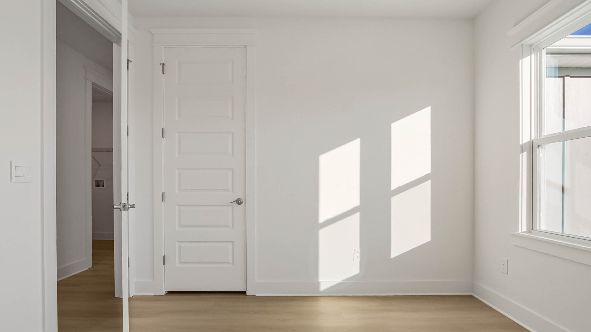 Bedroom three on second level with wood flooring