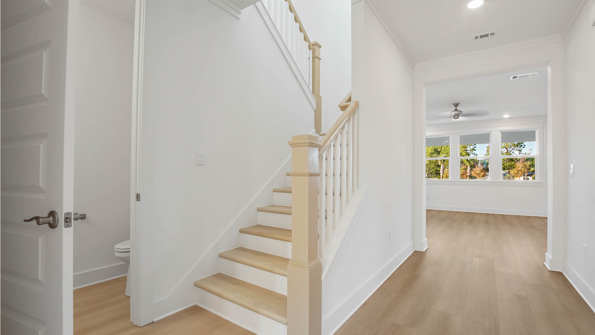 Stairs off the foyer that lead to the second level and powder room