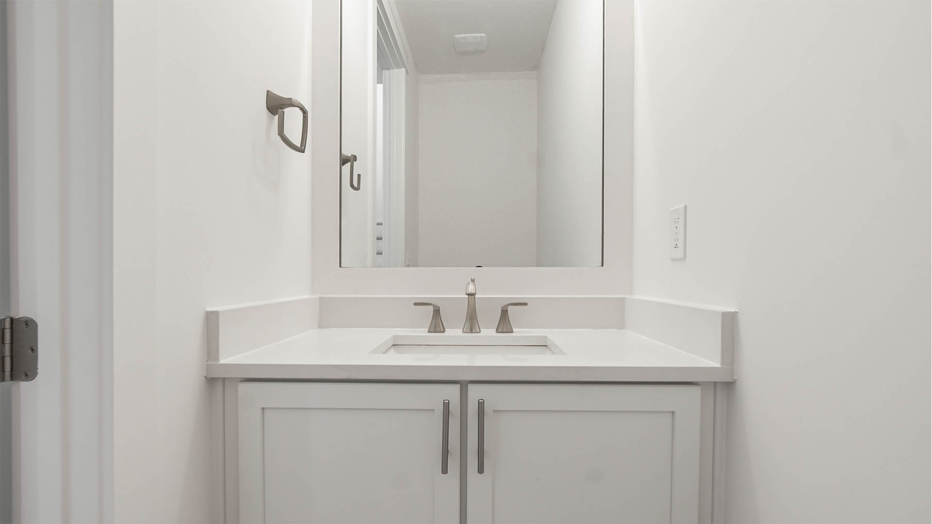 Powder room with vanity and quartz countertop