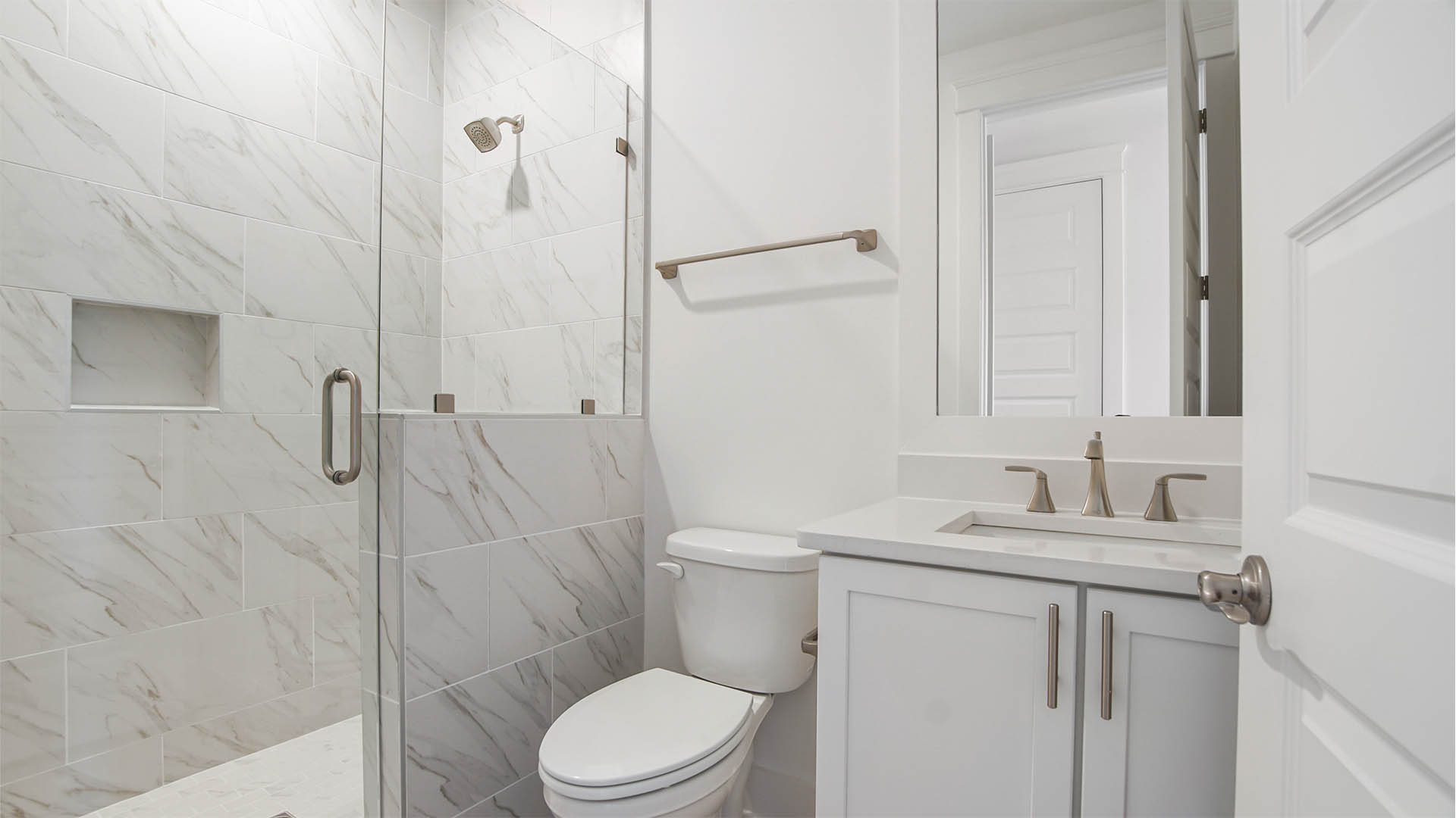 Private bath in bedroom two with vanity and quartz countertop