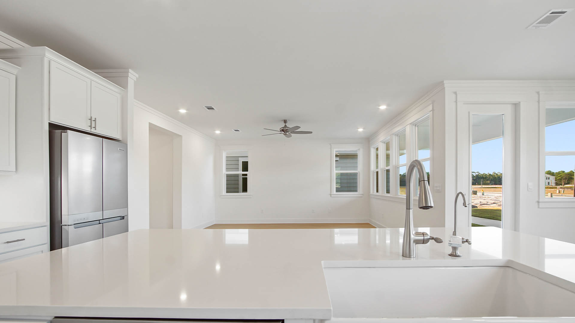 Farm style sink with pull down faucet and dishwasher with hidden control panel