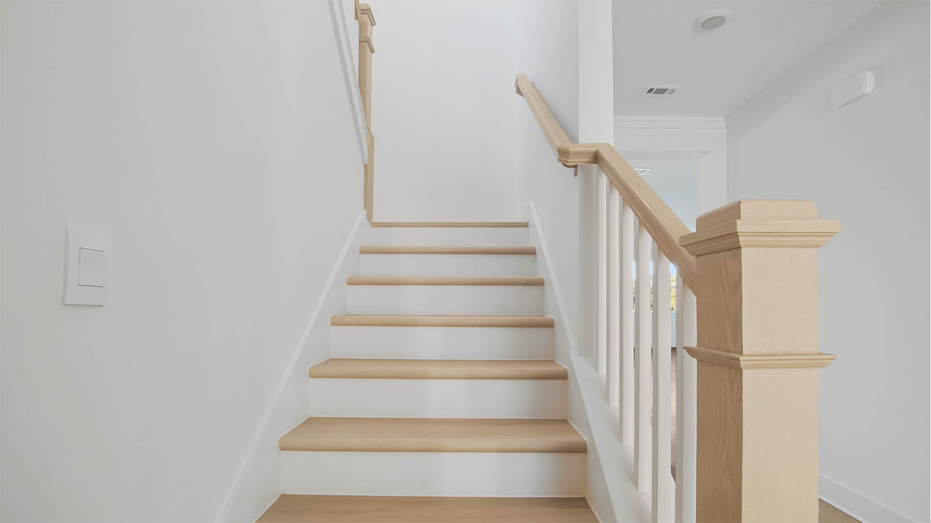 Wood stairs leading to the second level bedrooms