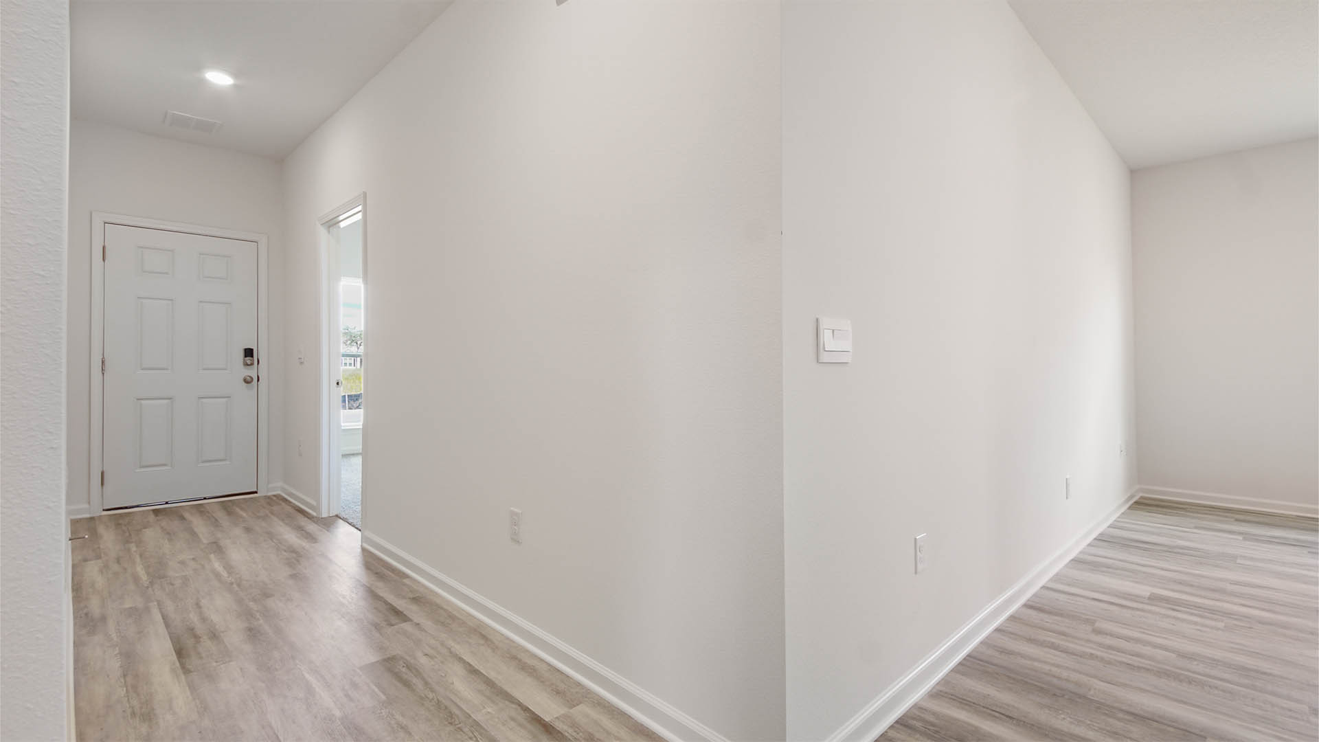 Front door and living room with EVP flooring.