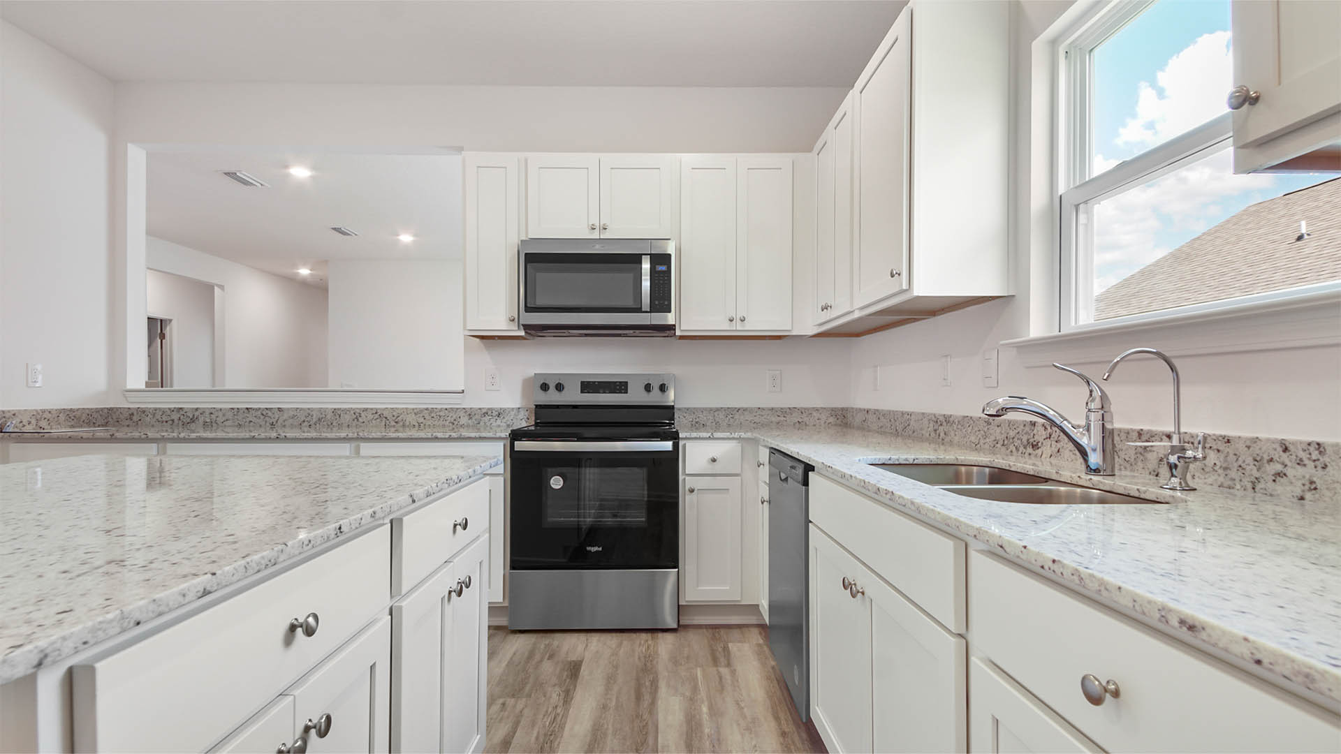 Kitchen with appliances and white cabinetry