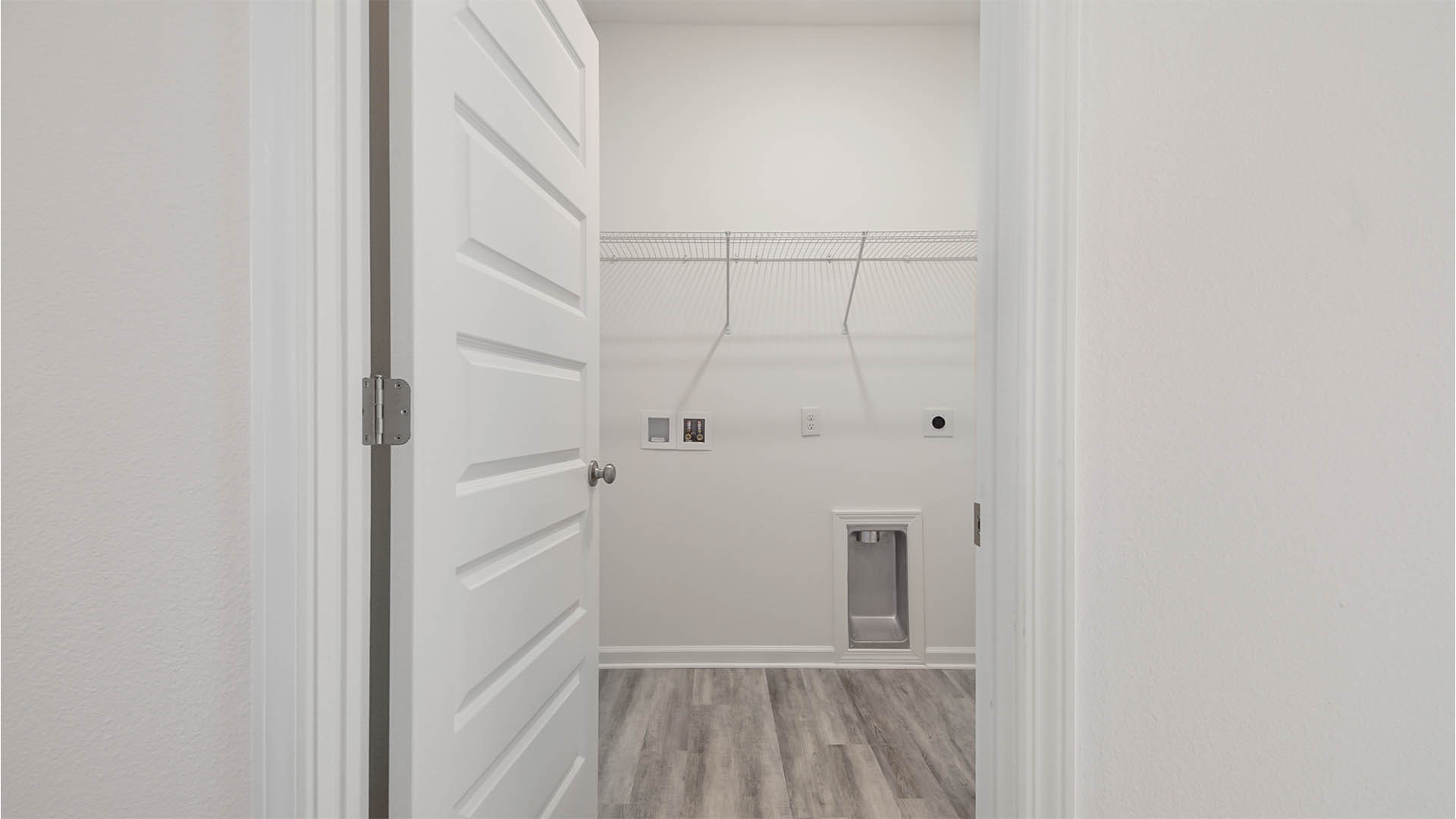 Laundry room with ventilated shelving.