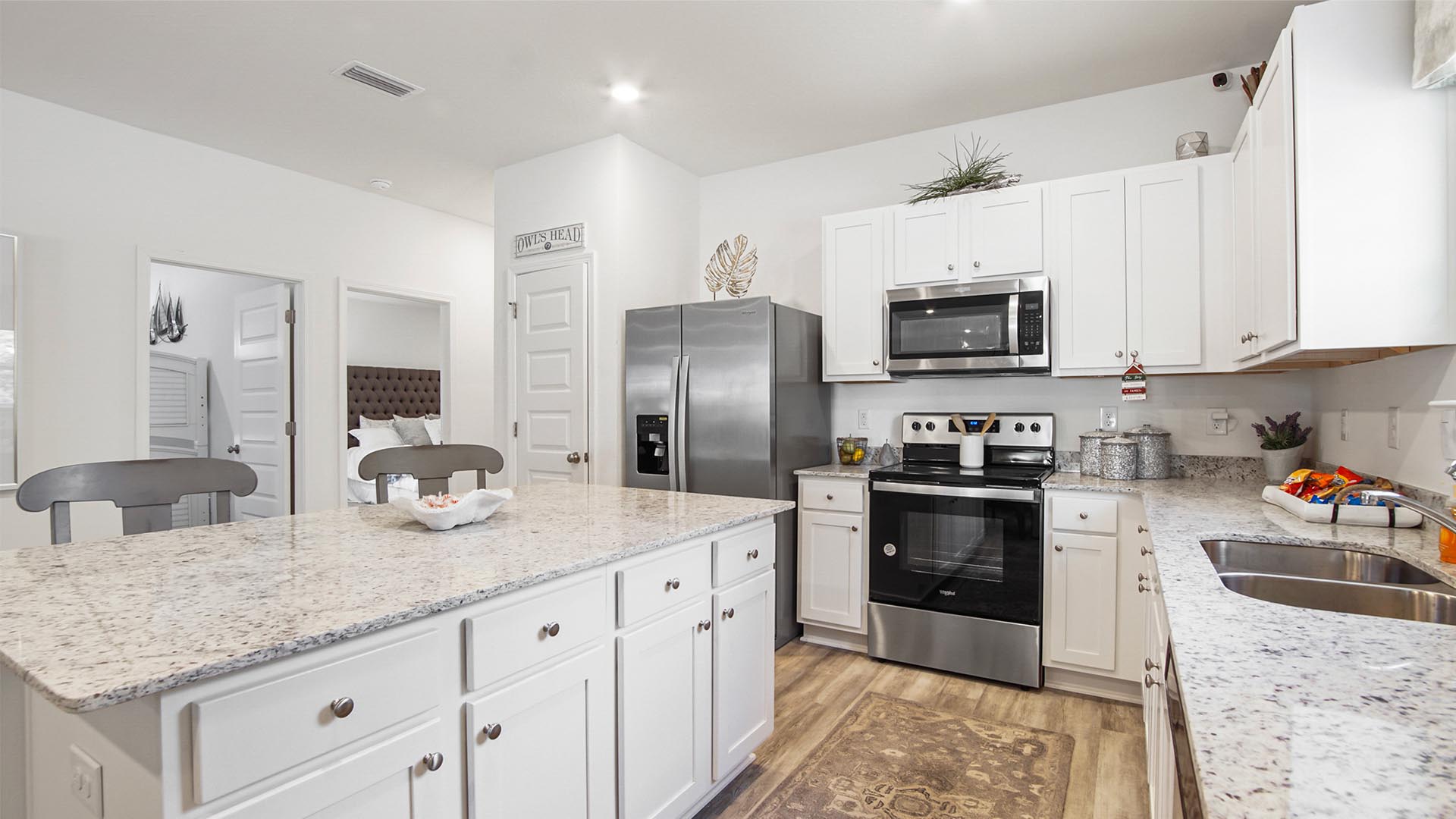 The kitchen features upper and lower cabinetry for storage