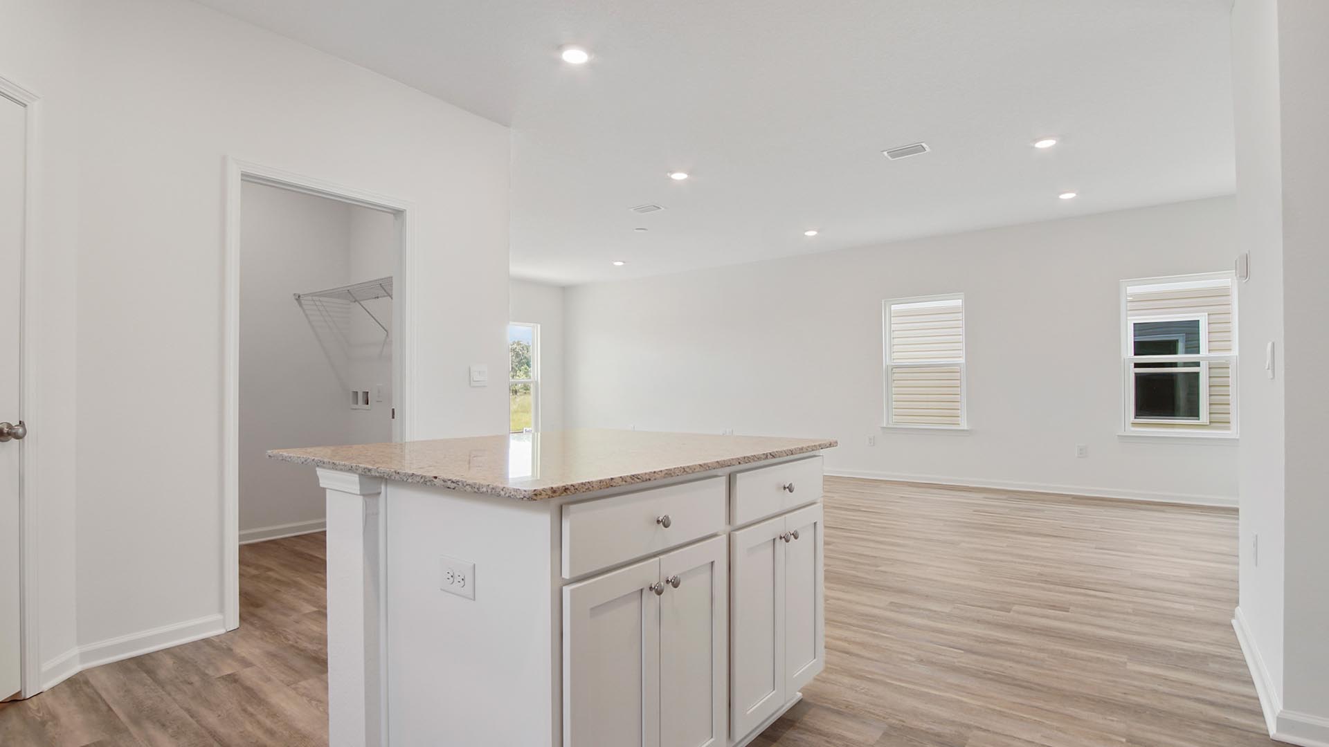 The center island has space for bar seating and lower cabinetry on one side