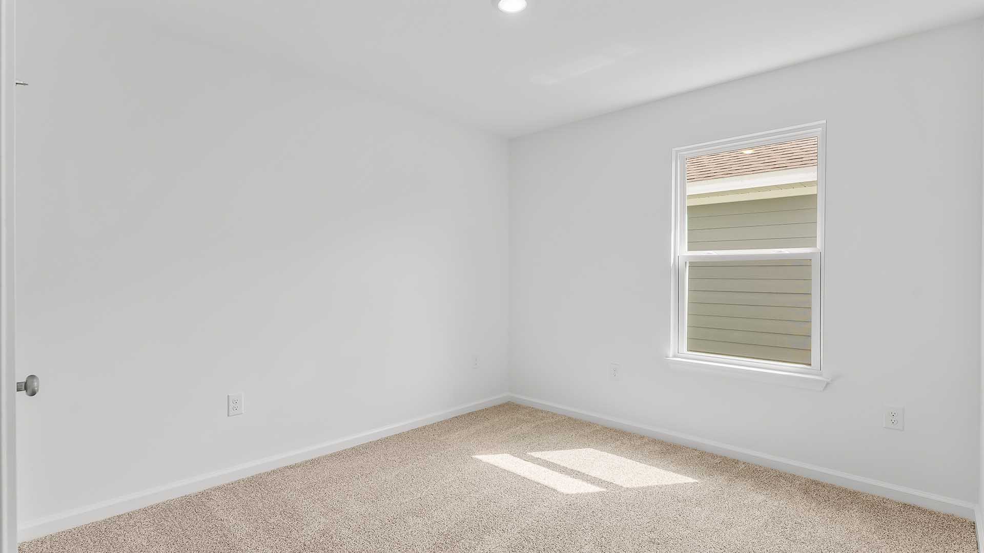 Bedroom three is located near the front of the home off the entry hall