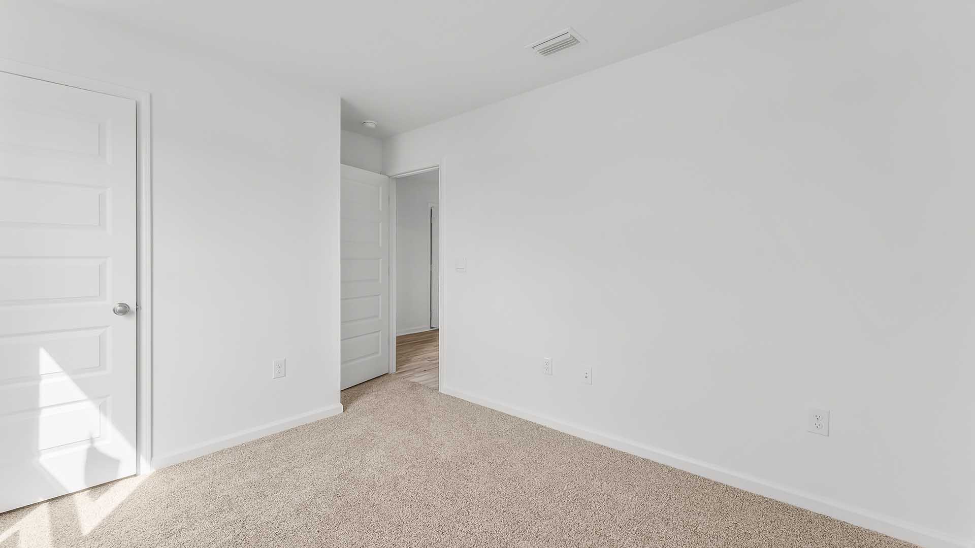 Guest bedroom two carpet and ample closet space