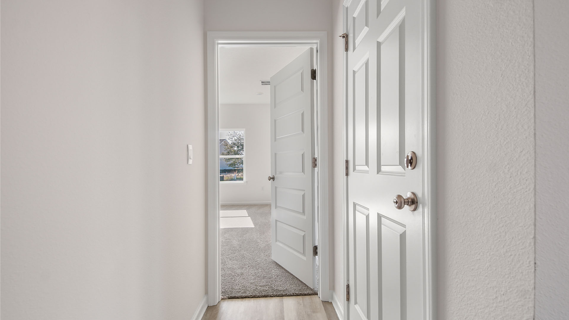 The primary bedroom has a separate hall