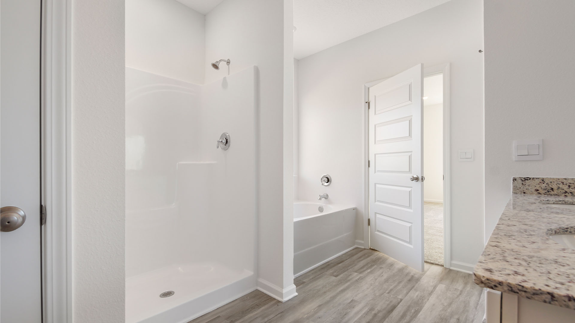 The primary bathroom has a separate shower and soak tub