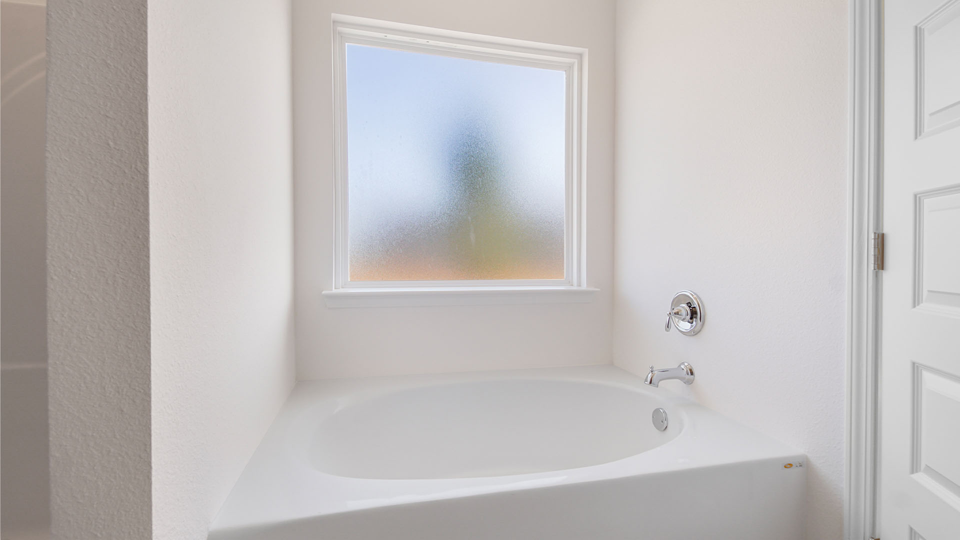 The soak tub has a frosted glass window for added light but complete privacy