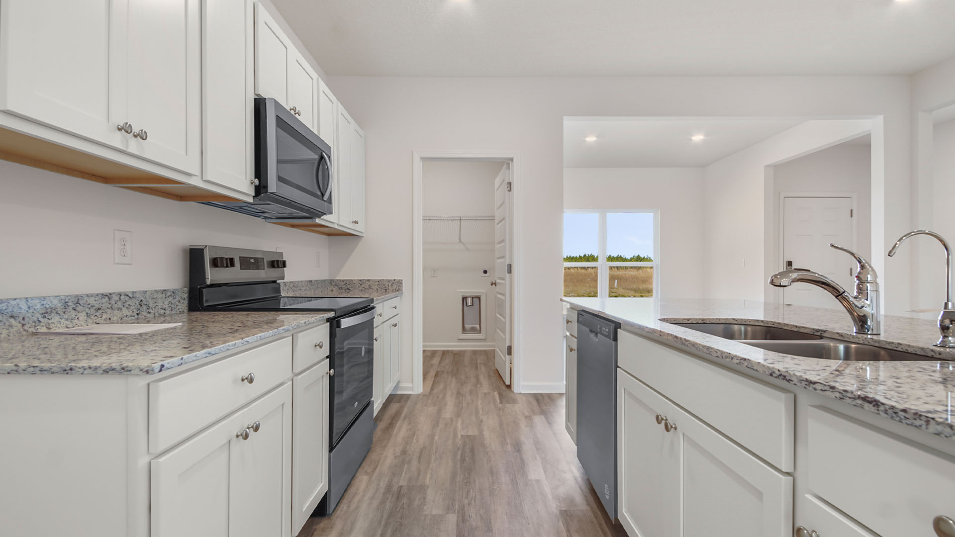 The kitchen comes equipped with stainless appliances and the island has a dishwasher and sink for easy meal prep and clean up