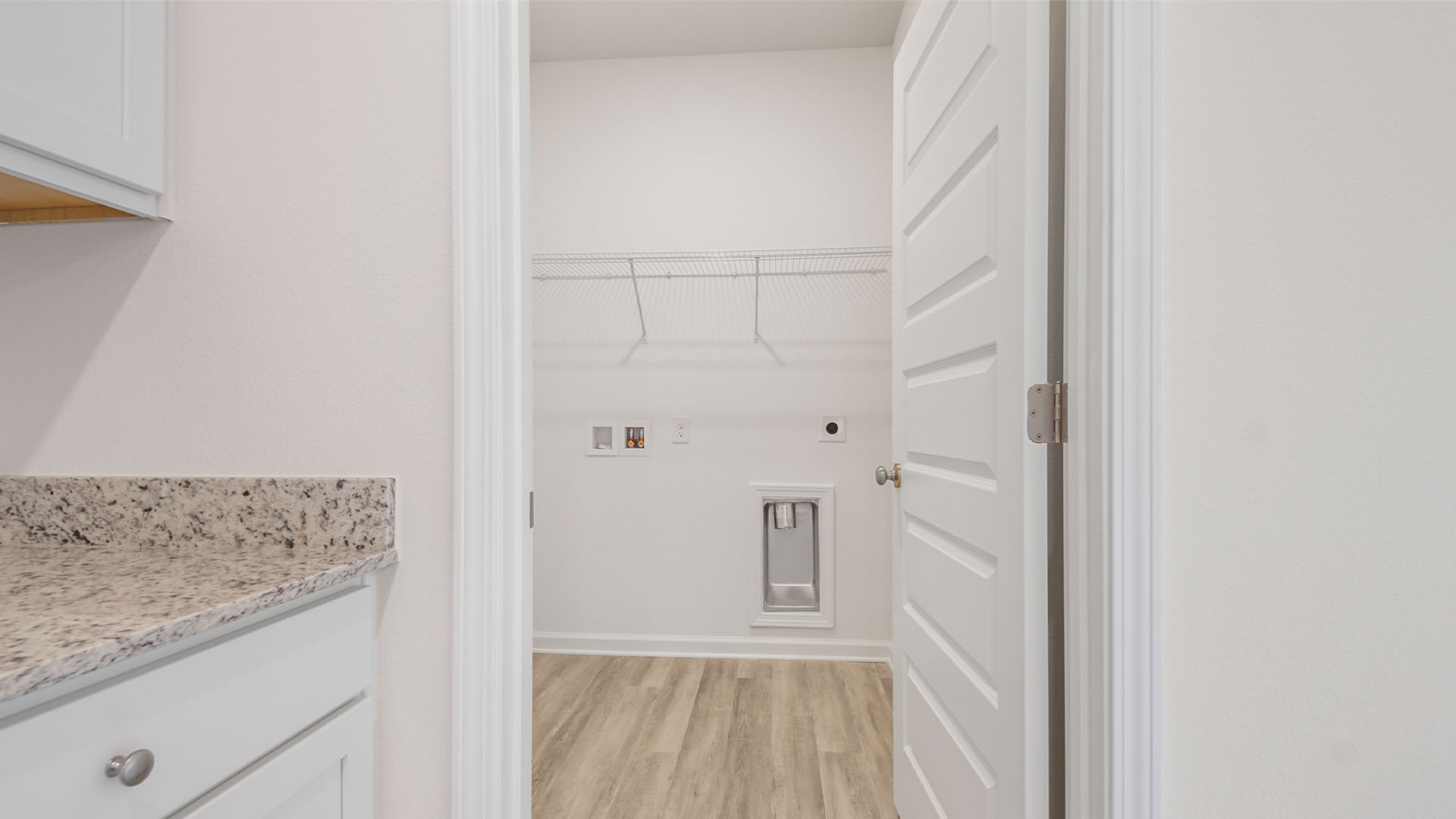 The laundry room is located off the kitchen and has space for a full size washer and dryer