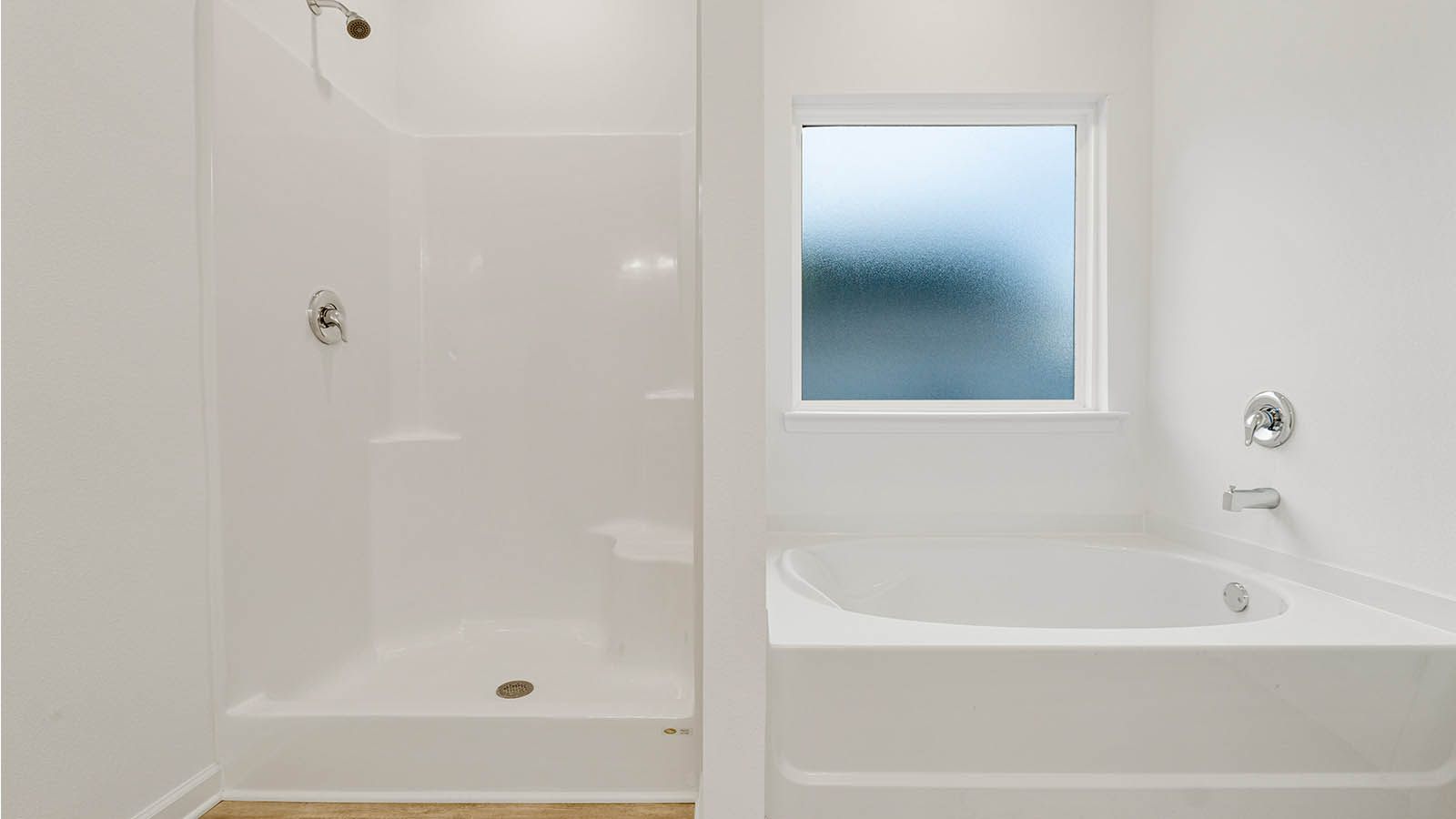 Separate shower and large soak tub in the primary bedroom of the Mason floor plan