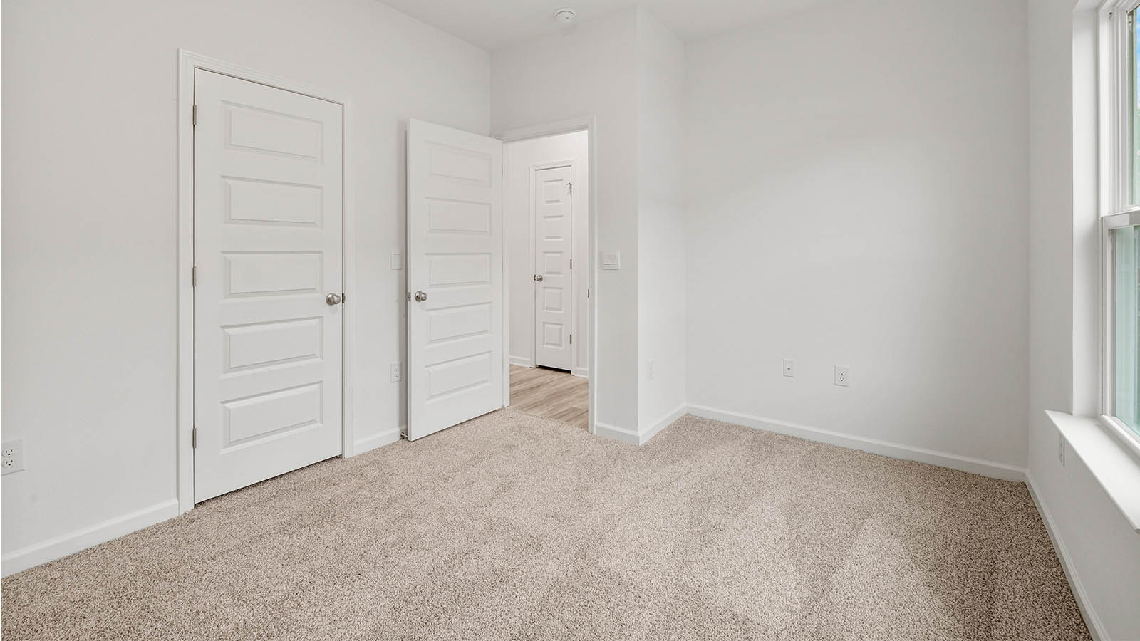 Spacious bedroom three is located off the large family room