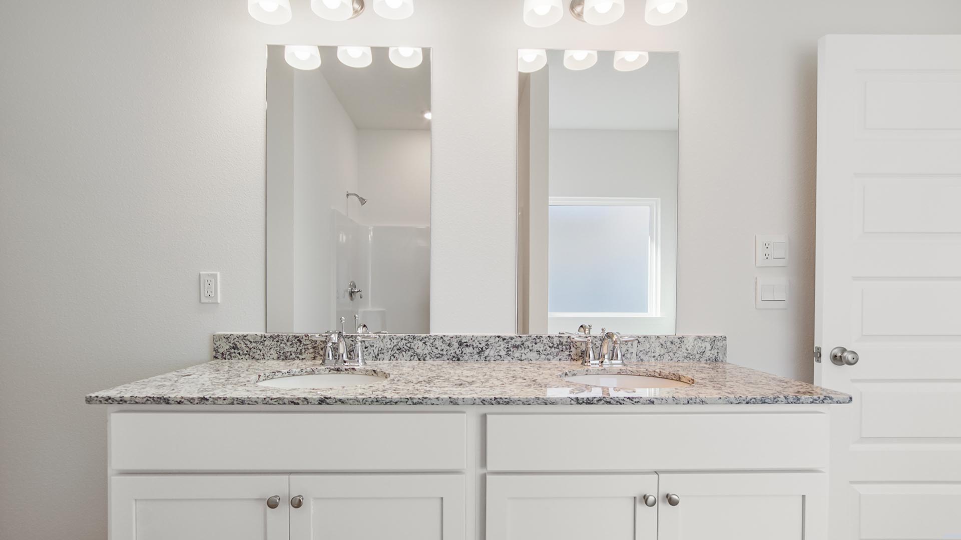 The dual sink vanity is beautiful white cabinetry and lower storage as well as classic granite countertops
