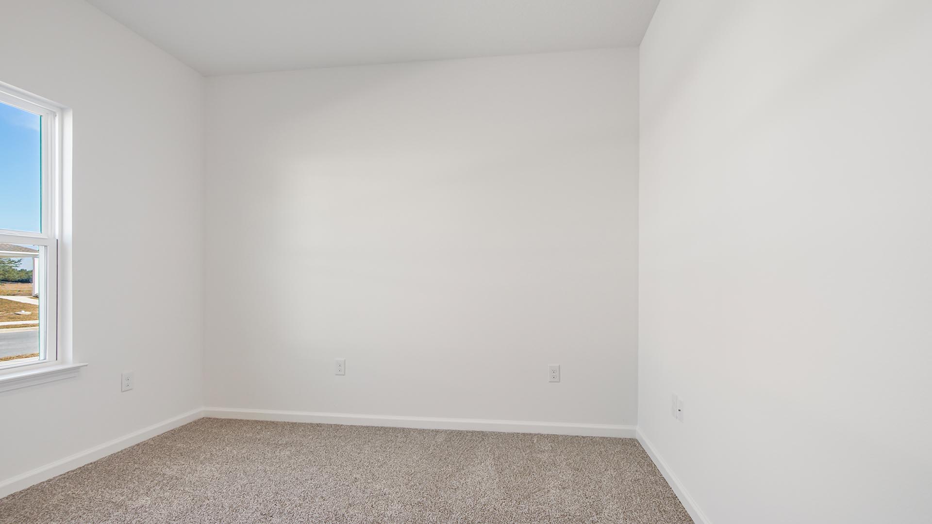 Bedroom three is located at the front of the home overlooking the lawn