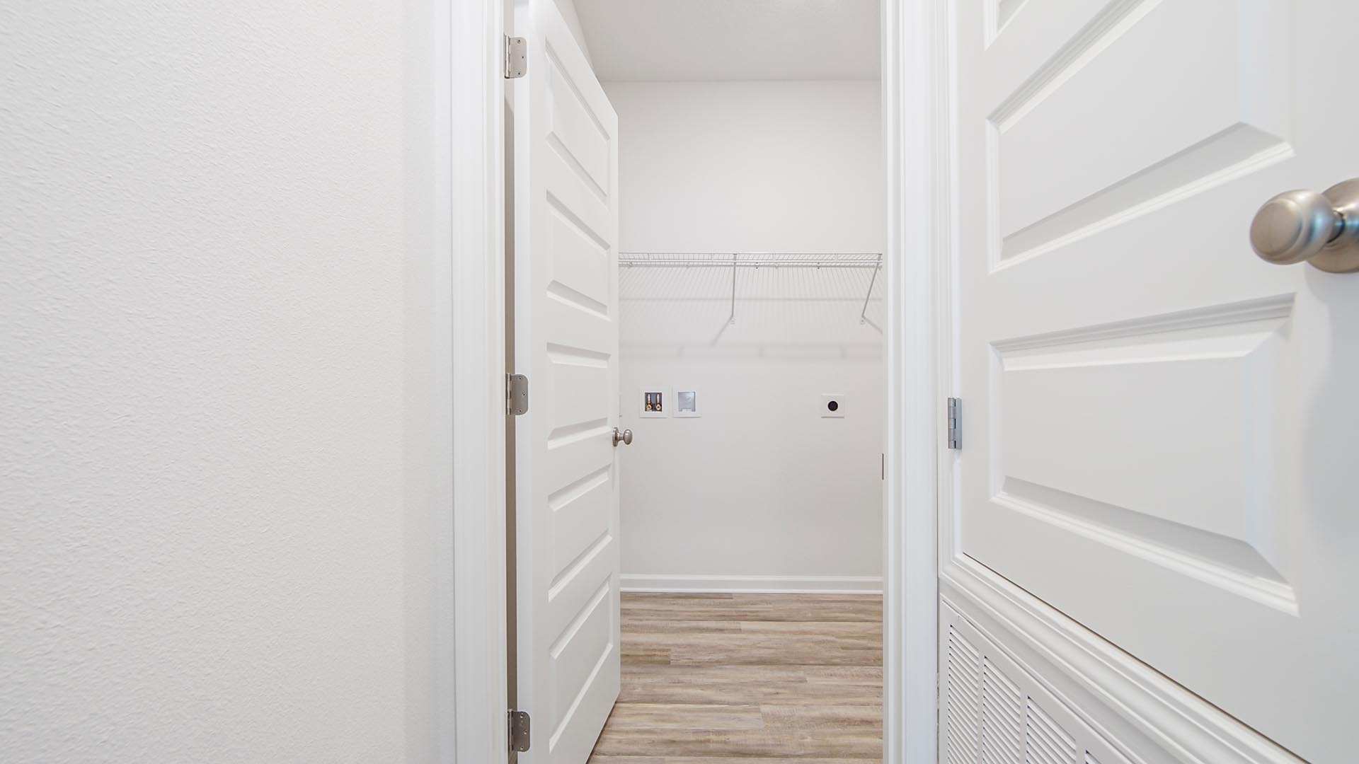 The laundry room is spacious and has space for a full size washer and dryer