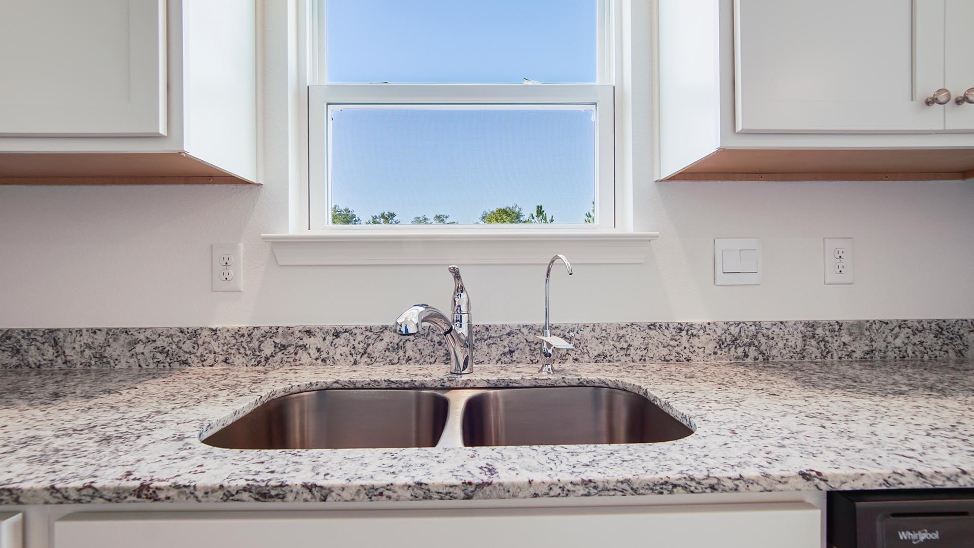 The stainless sink basin has a separate faucet for filtered water