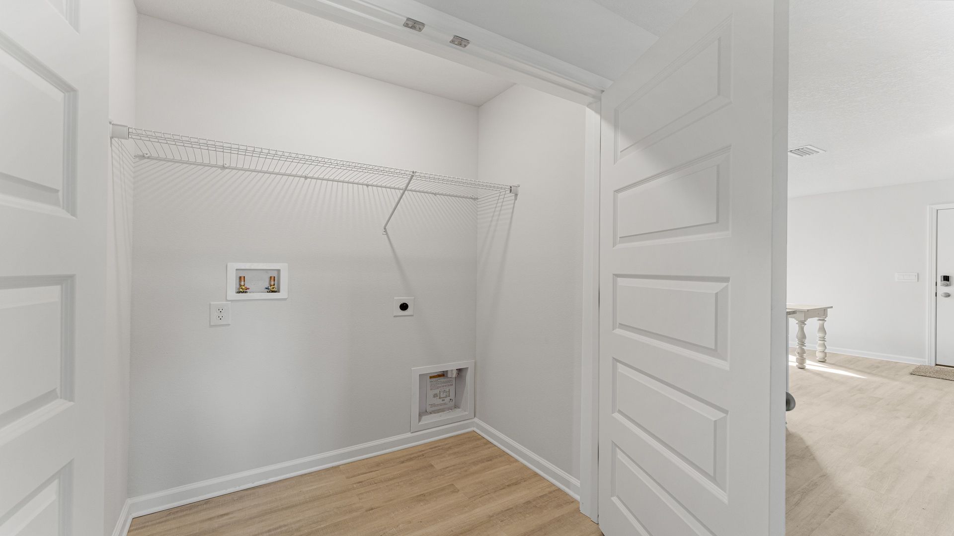 Laundry area with upper sheliving