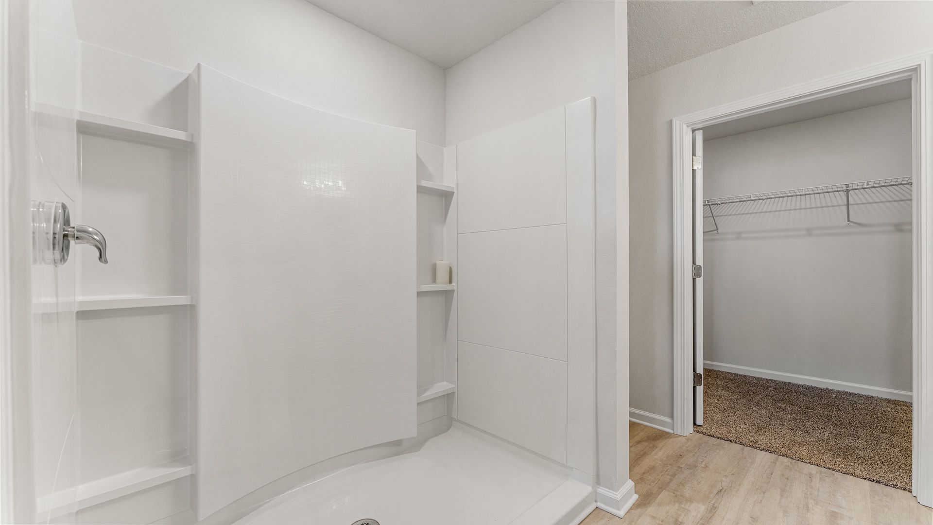 Primary bathroom with EVP flooring and oversize shower