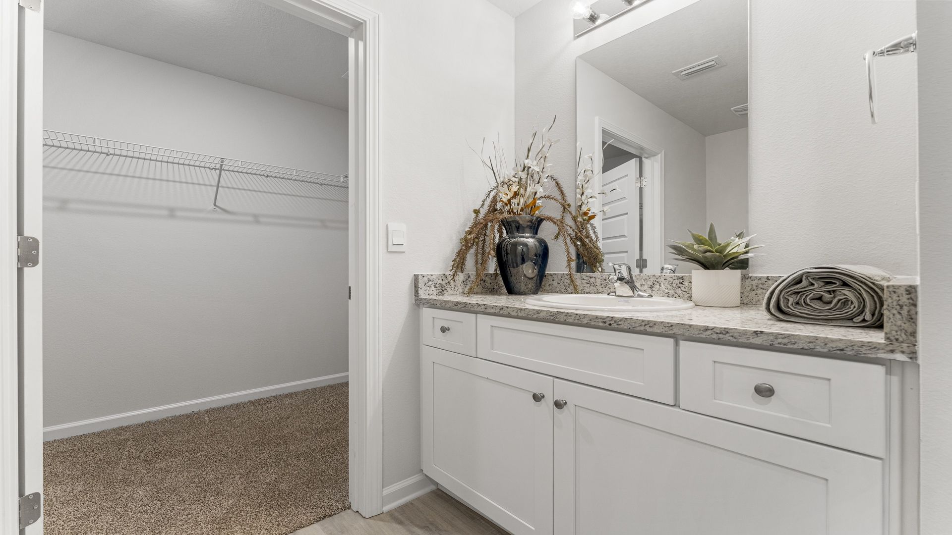 Primary bathroom with vanity and granite countertops
