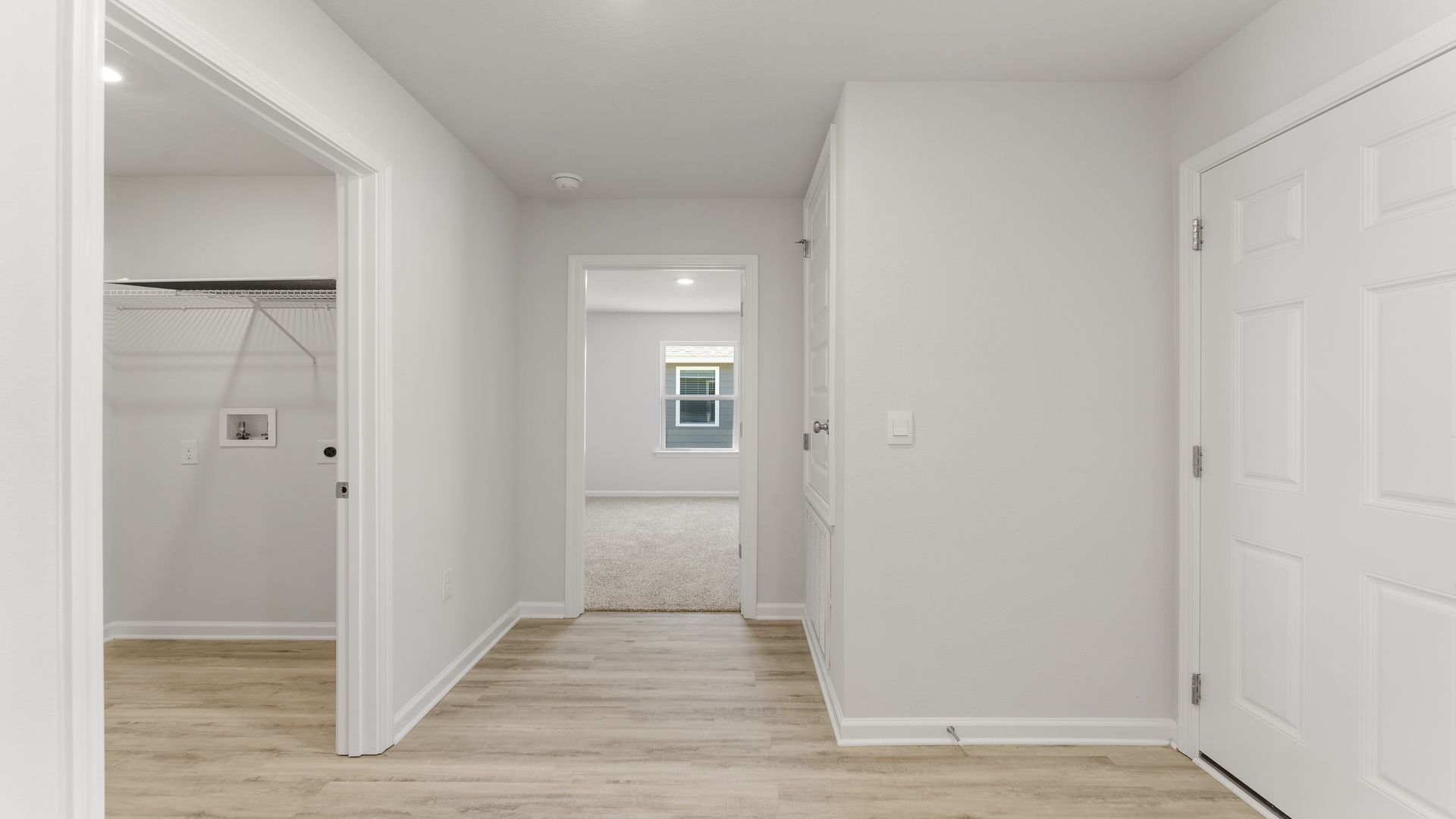 Separate hallway leads to bedroom four, the laundry room and garage