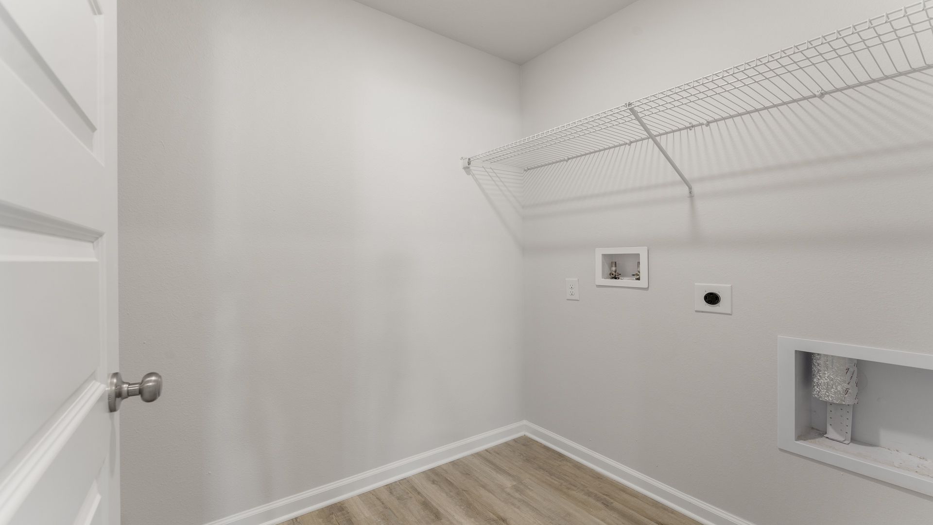 The laundry room has space for a full size washer and dryer