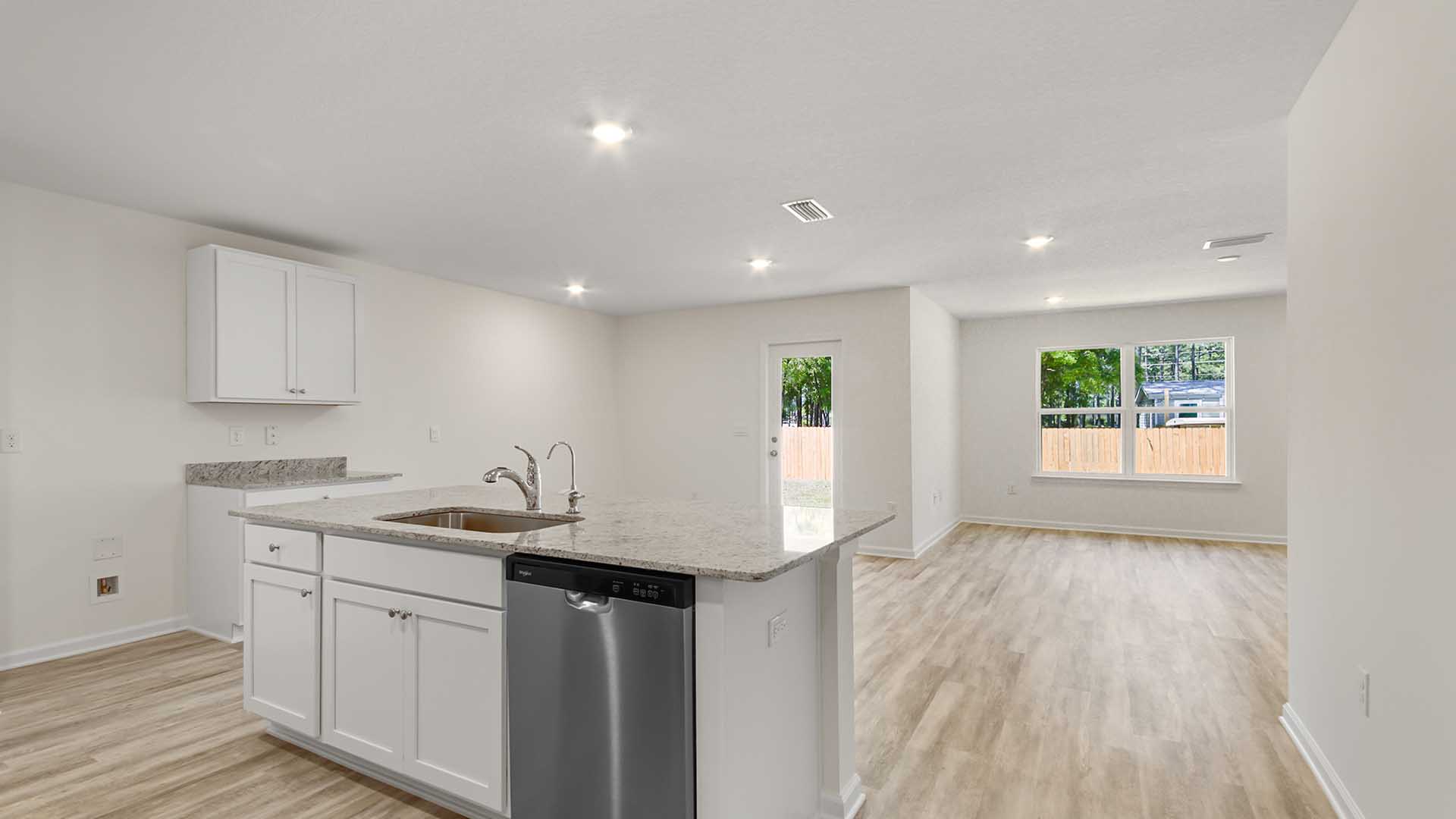 The kitchen opens to the dining and living areas