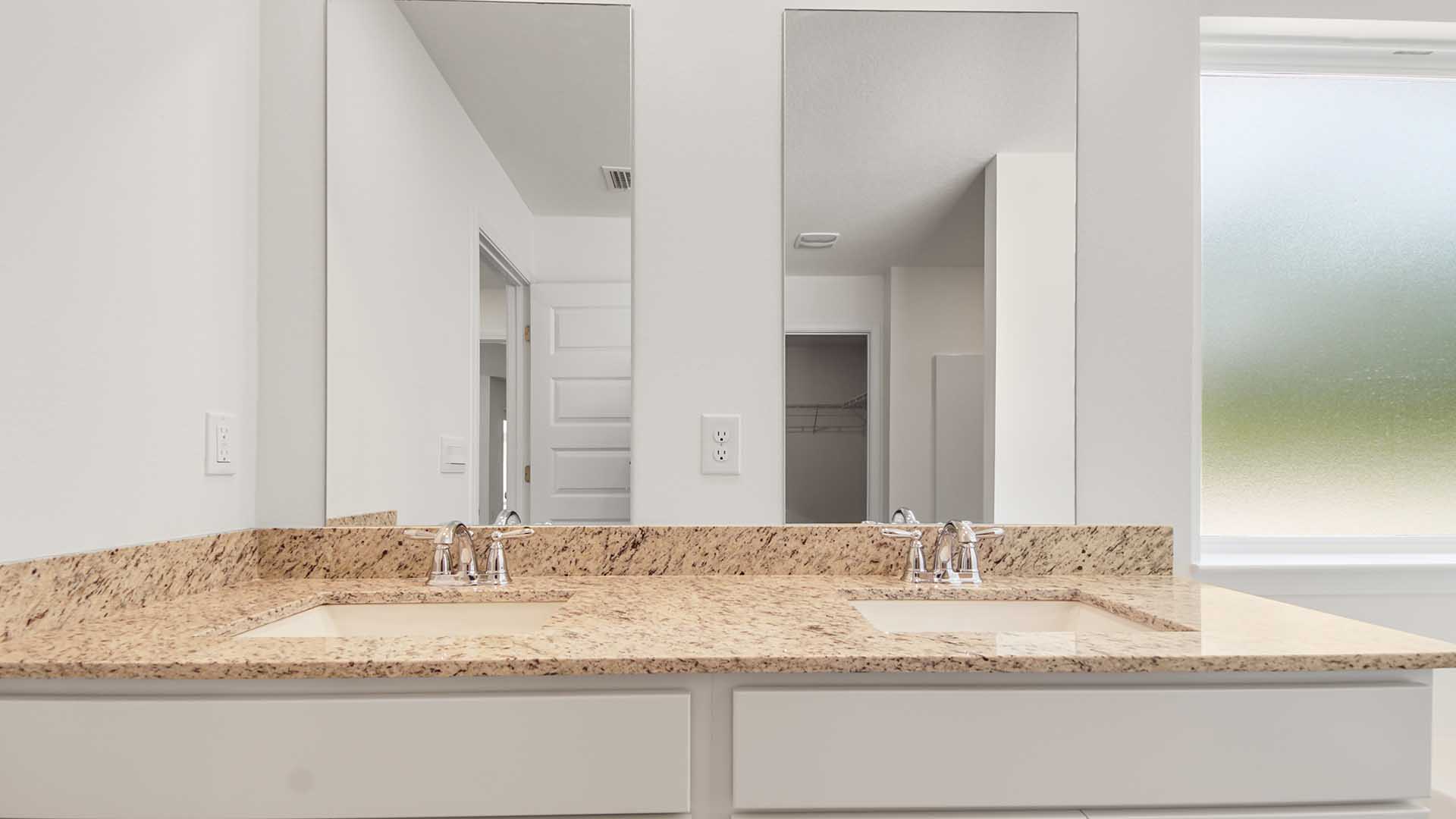 The primary bathroom has a vanity with dual sinks