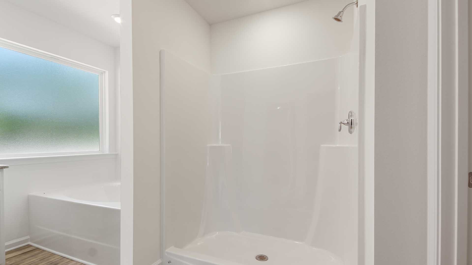 The vanity has granite countertops and lower cabinetry and drawers for storage