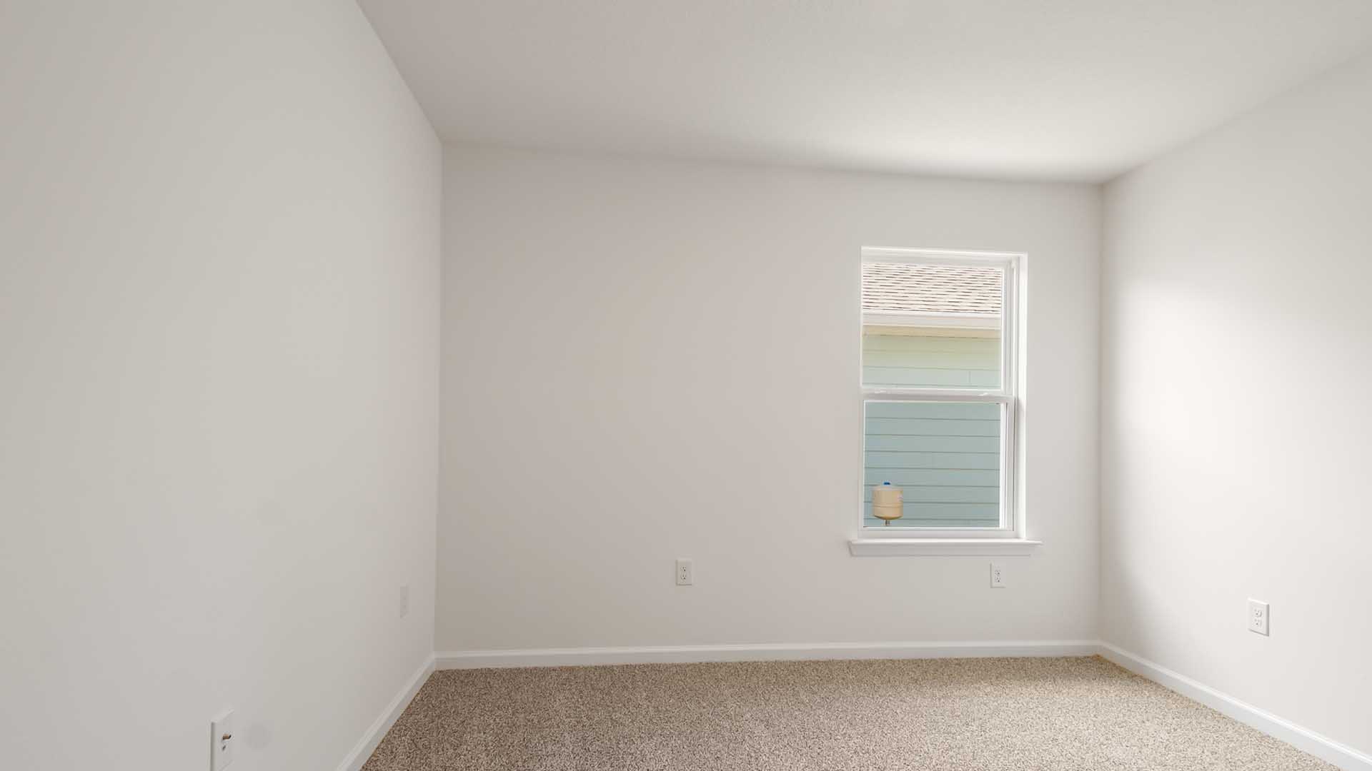 Bedroom three is located on the side of the home