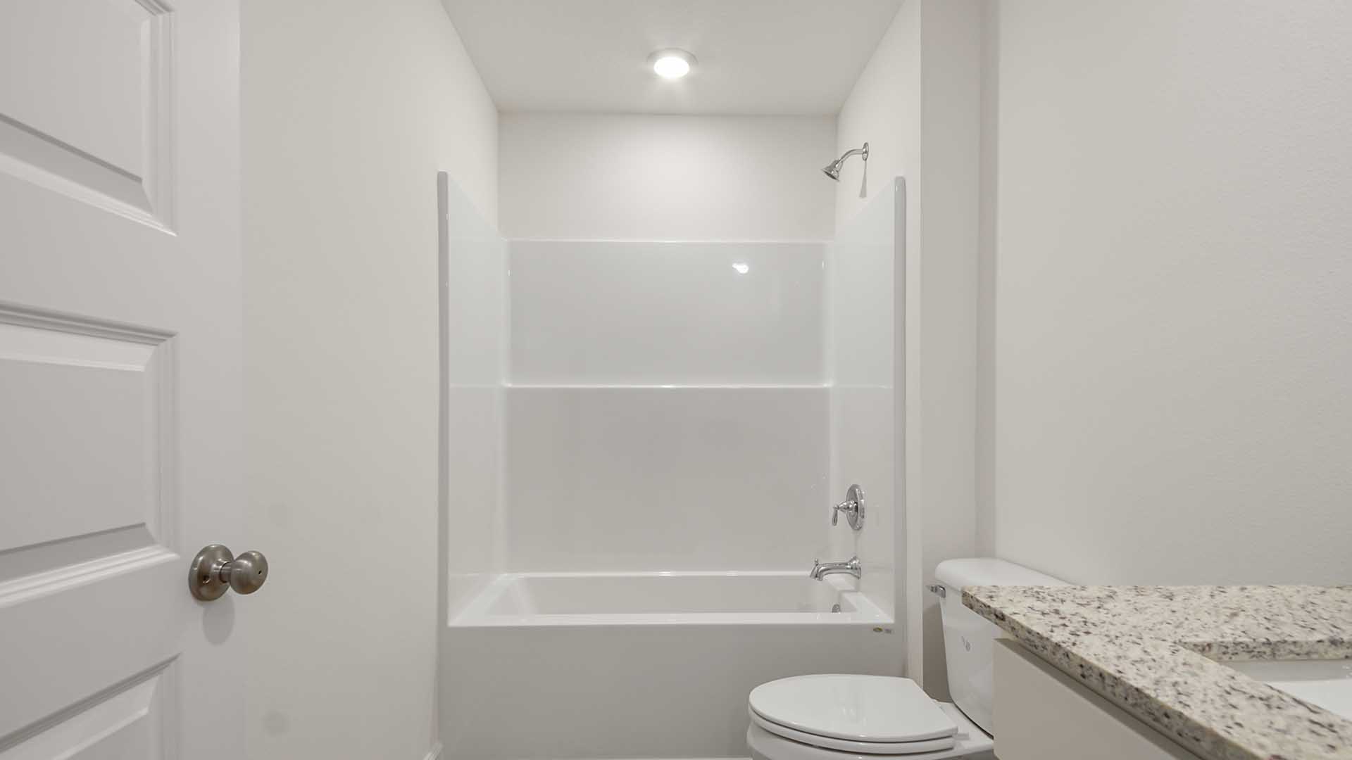 The shared bathroom has a shower and tub combination