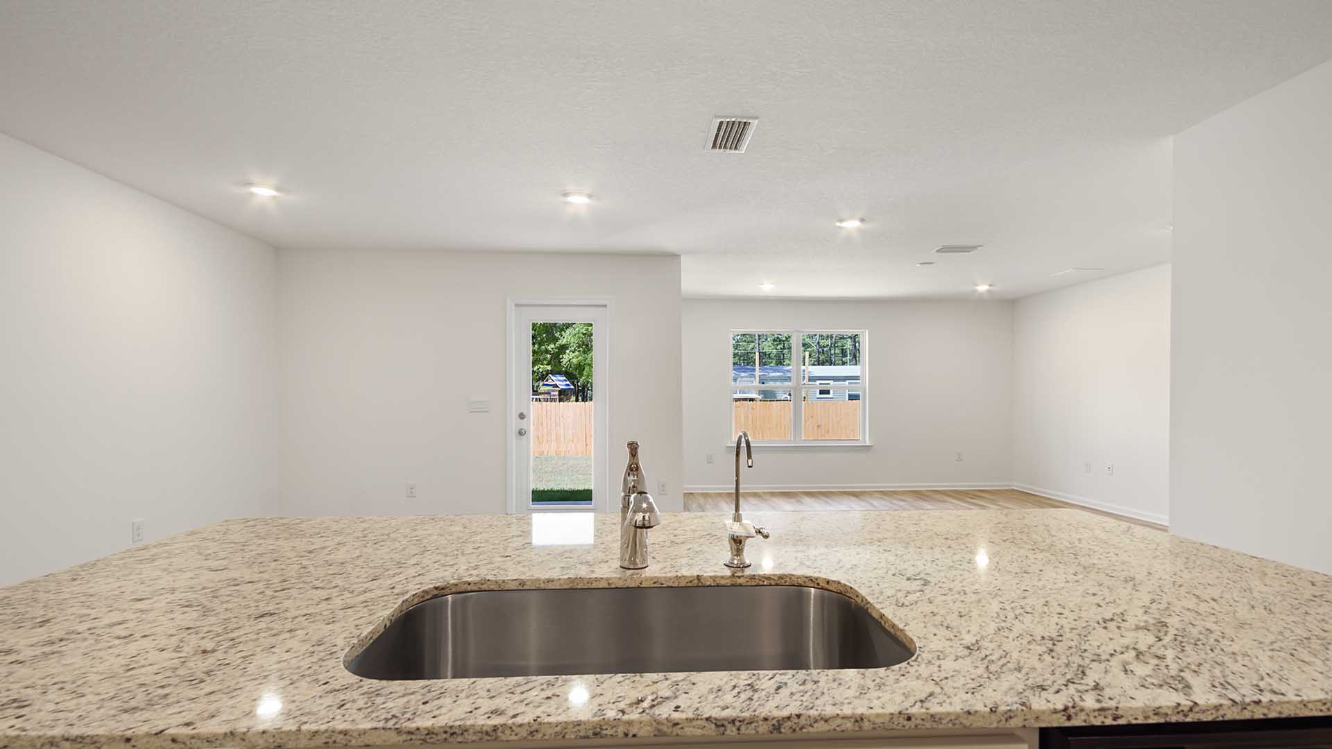 The center island has a quartz countertop, a sink and dishwasher for ease of meal prep and cleanup