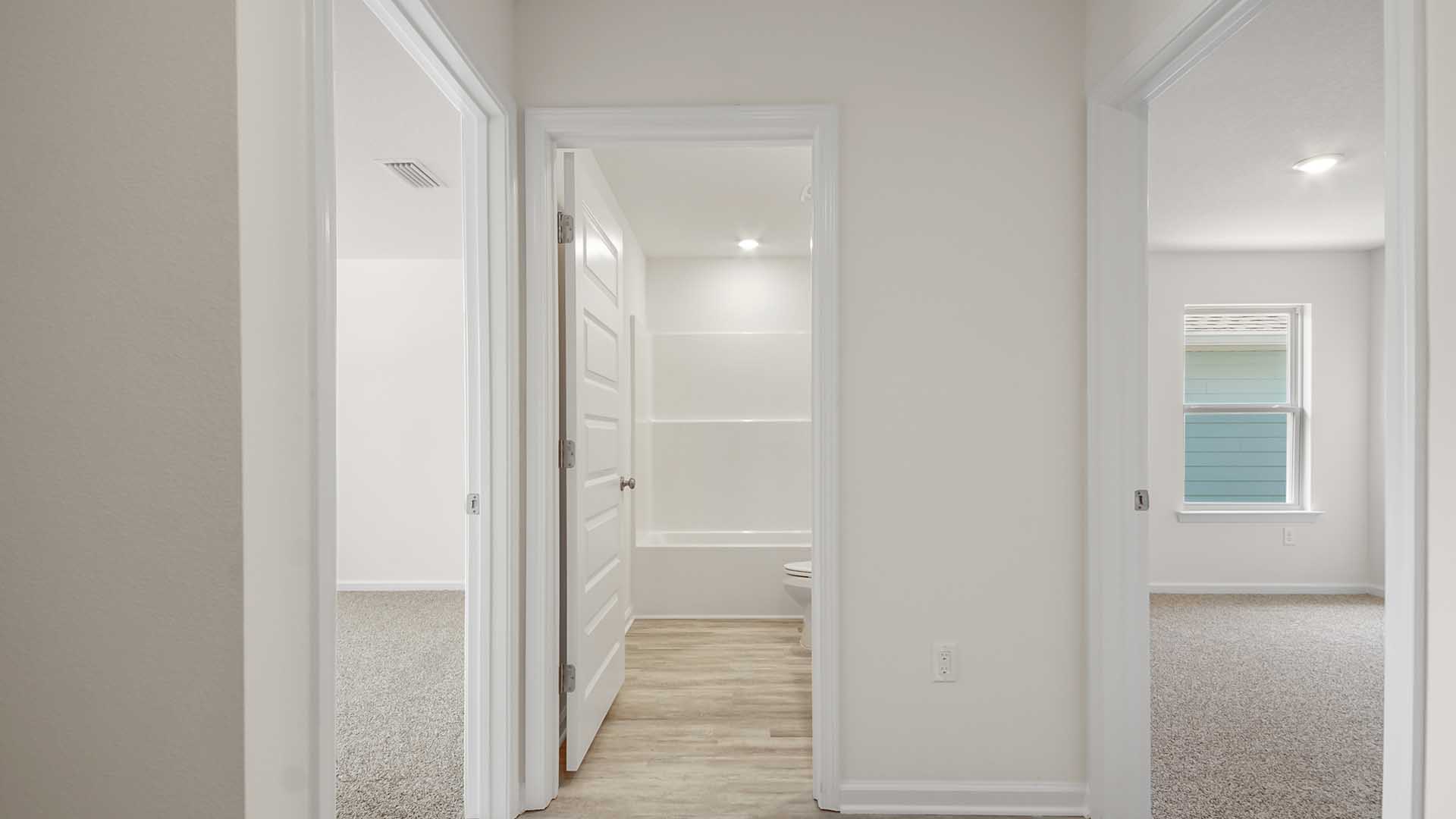 Hall leading to bedrooms two and three has EVP floors. Each bedroom has carpet
