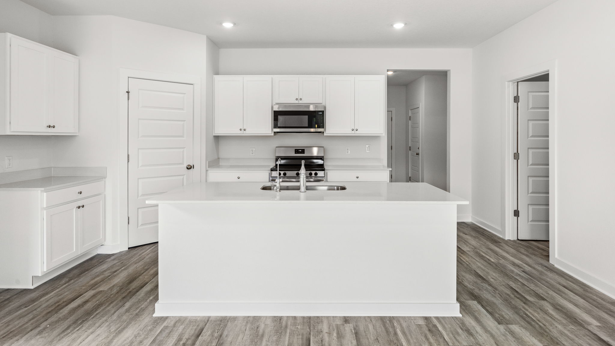 The kitchen has plenty of upper and lower cabinetry for storage