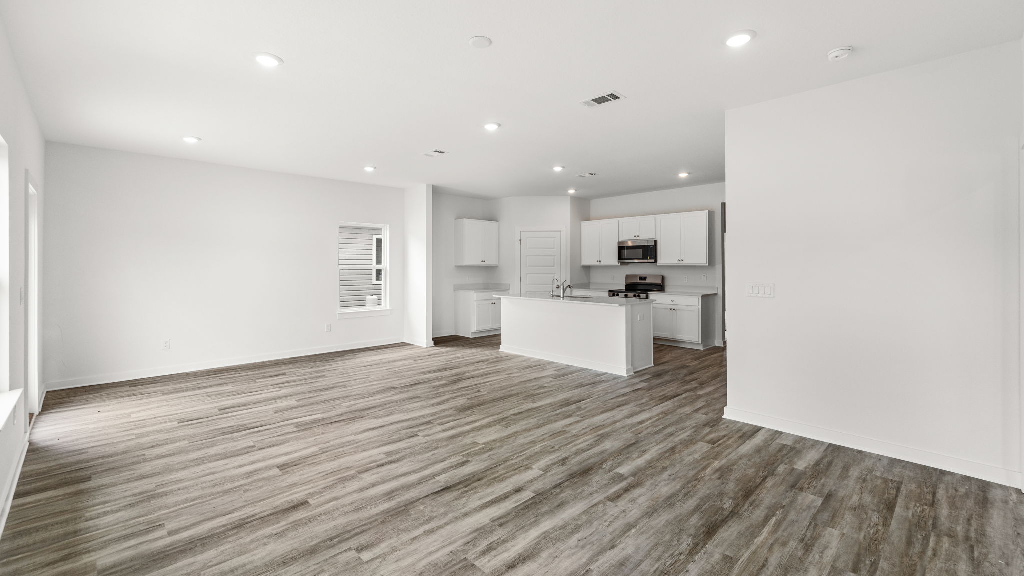 The living area has multiple windows for natural light