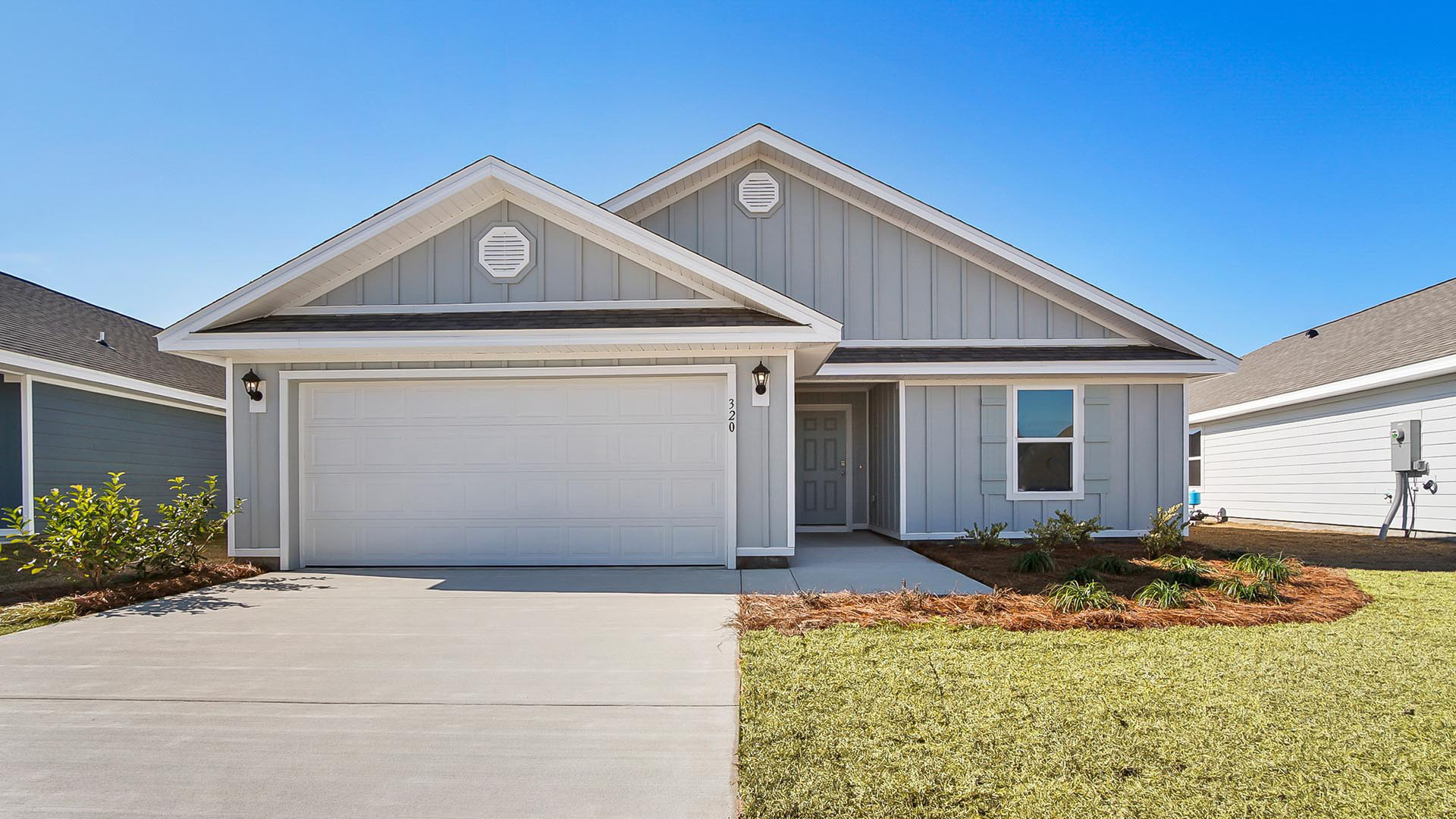 4127 Merrick Drive is a preconstruction homesite to be developed with the Lismore floor plan. This image shows a similar Lismore at completion with gray vinyl siding and a covered entry